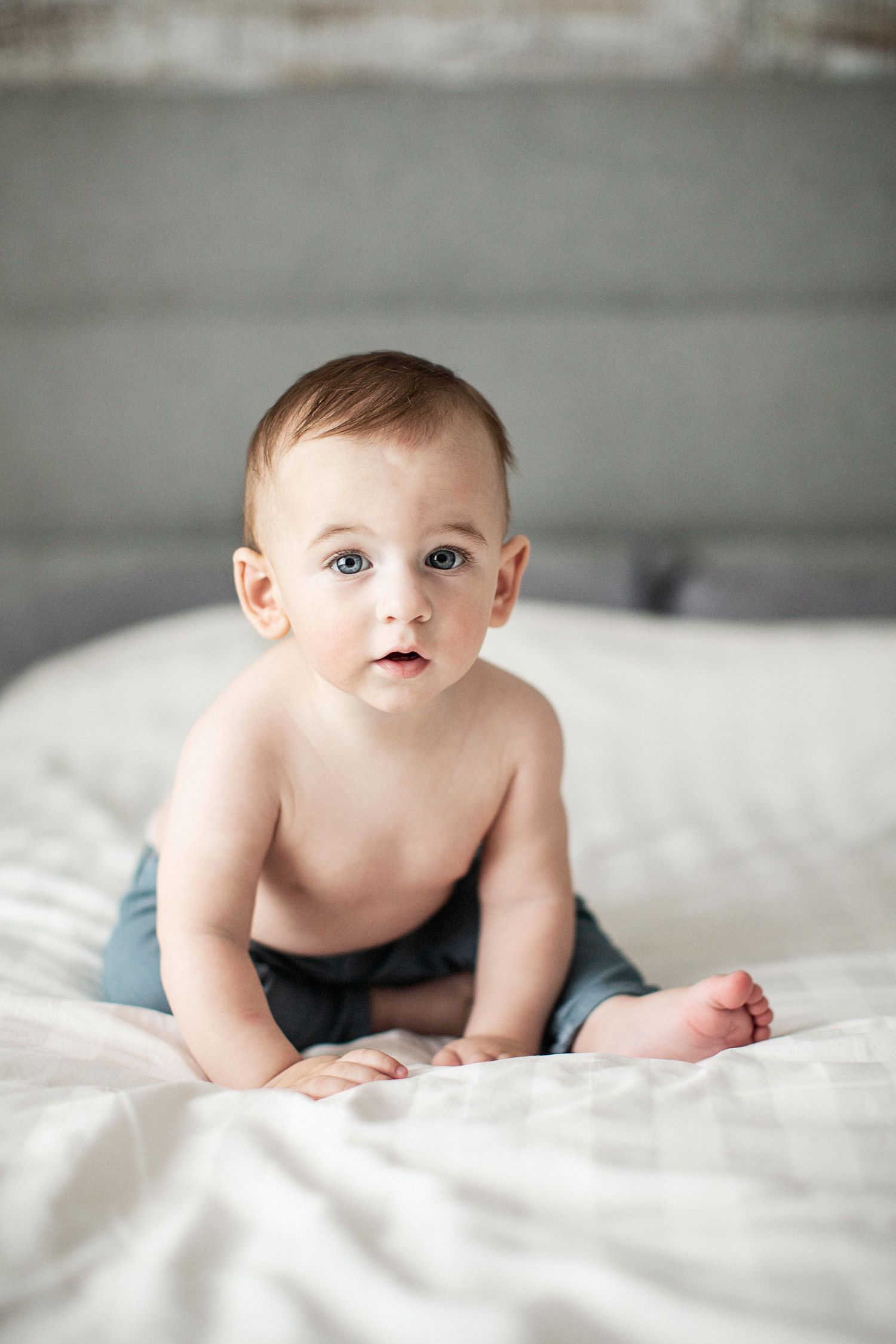 Portrait of a baby on a bed.