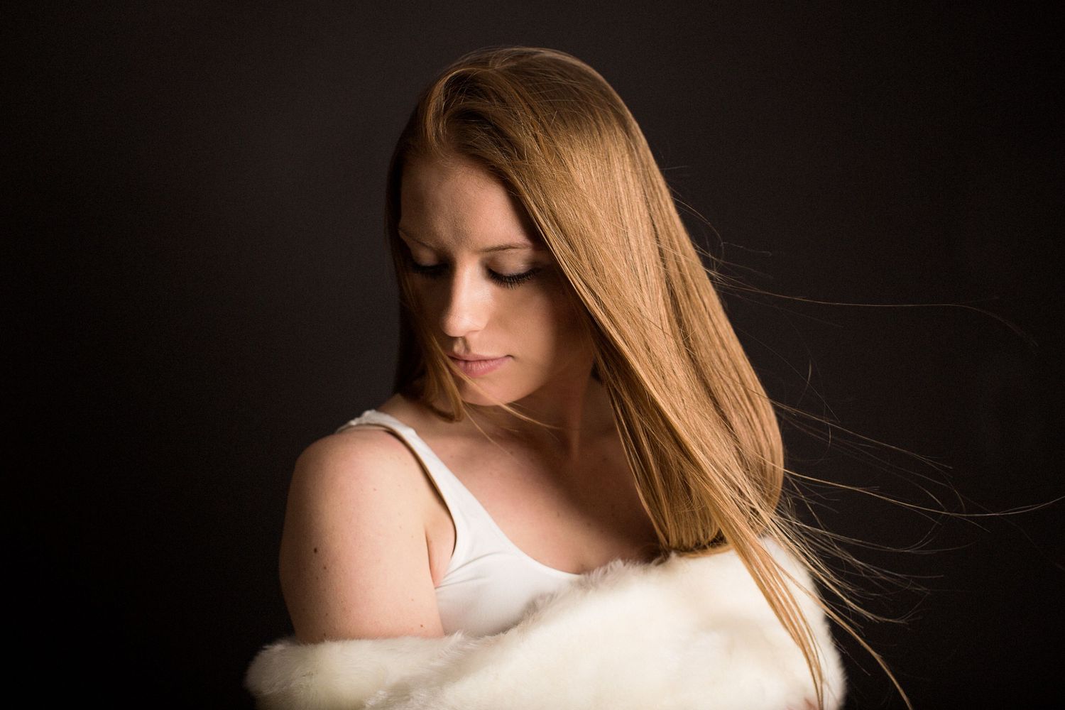 Studio photo of a model with red hair.