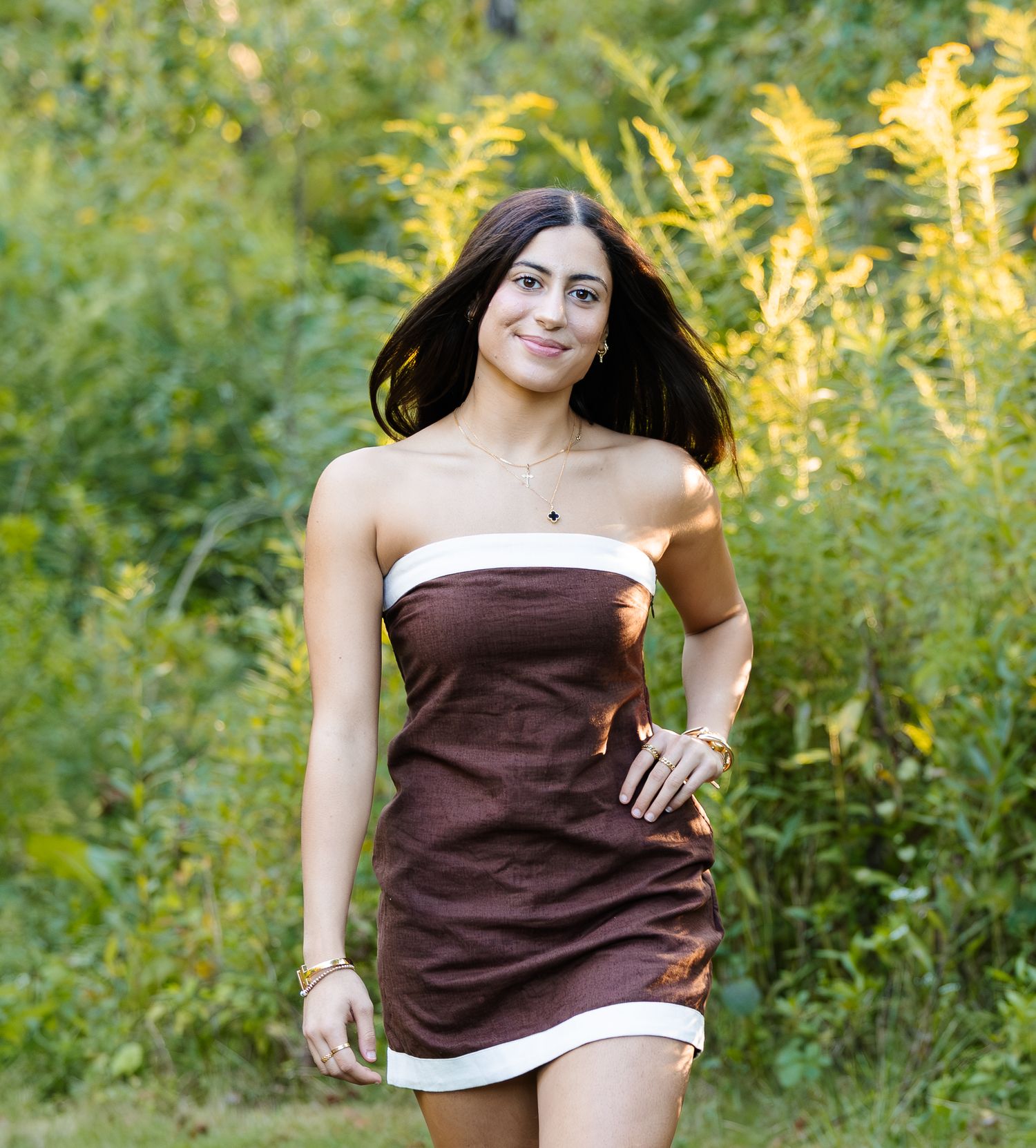 Portrait series in a brown dress surrounded by summer greenery.