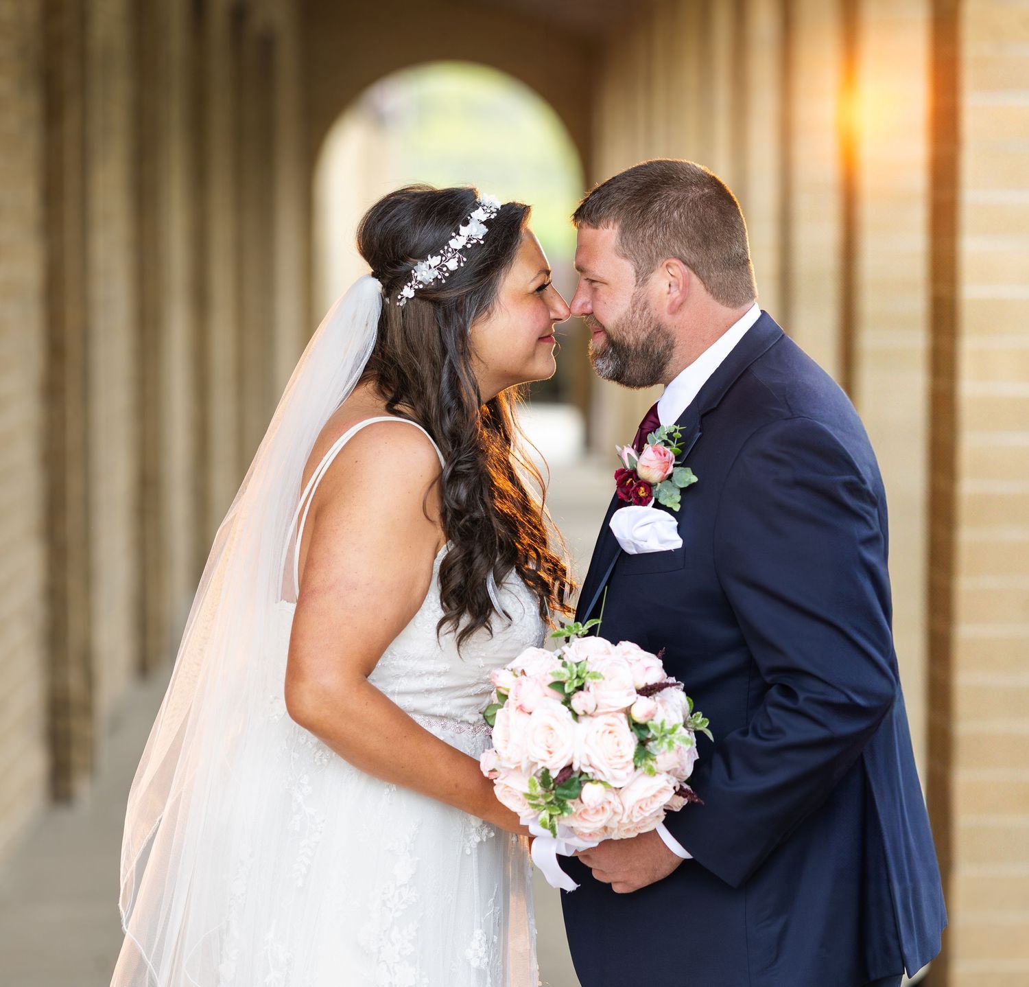 A romantic wedding photo series showing tender moments between newlyweds in an elegant venue.
