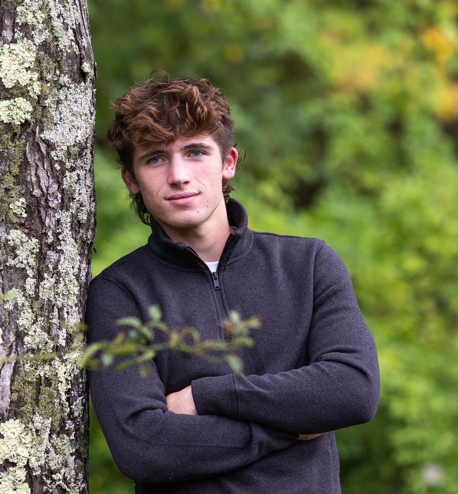 Portrait series against birch trees showing casual poses in black sweater.