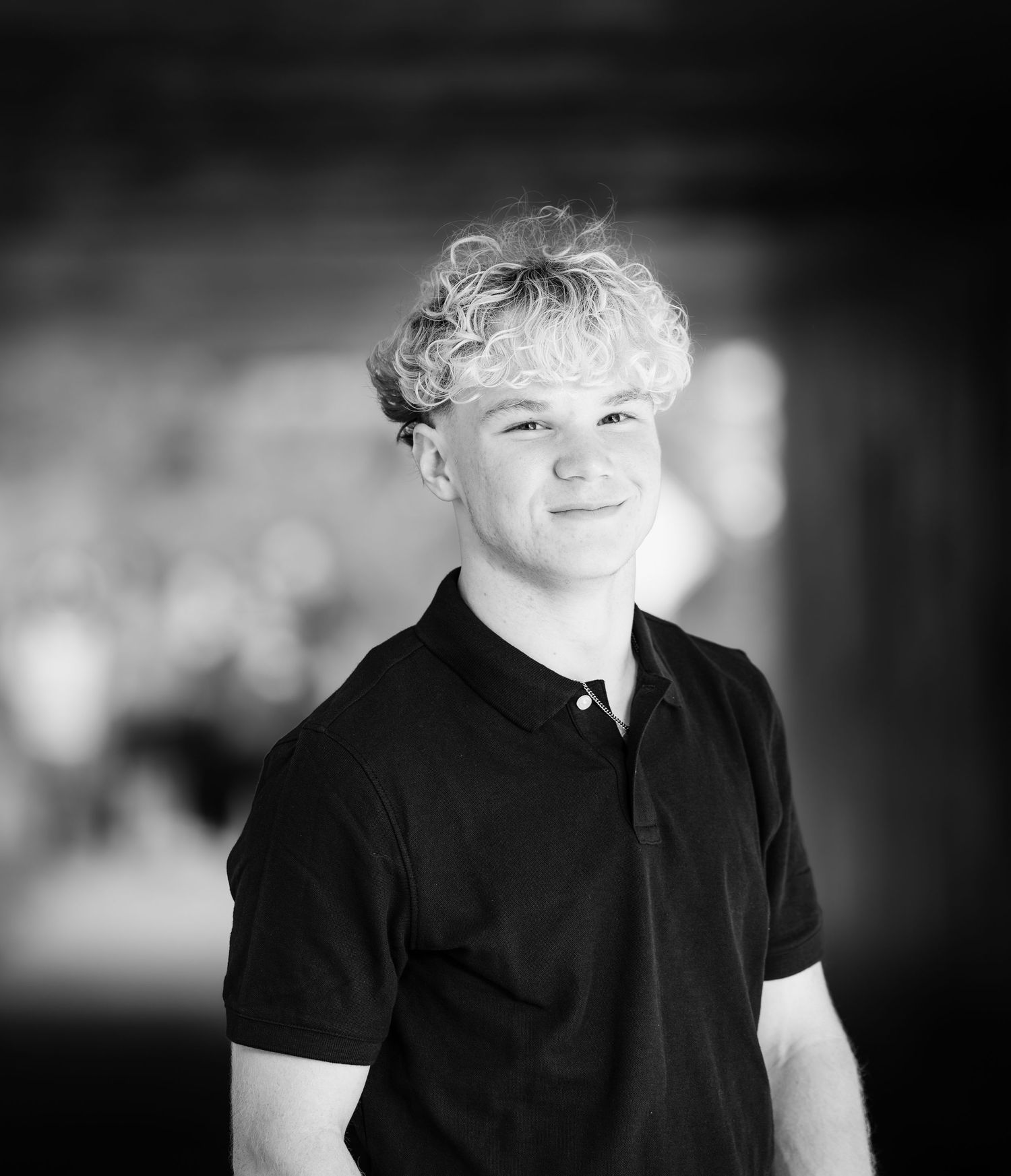 Black and white portrait photo series showing different angles and expressions in dramatic lighting.