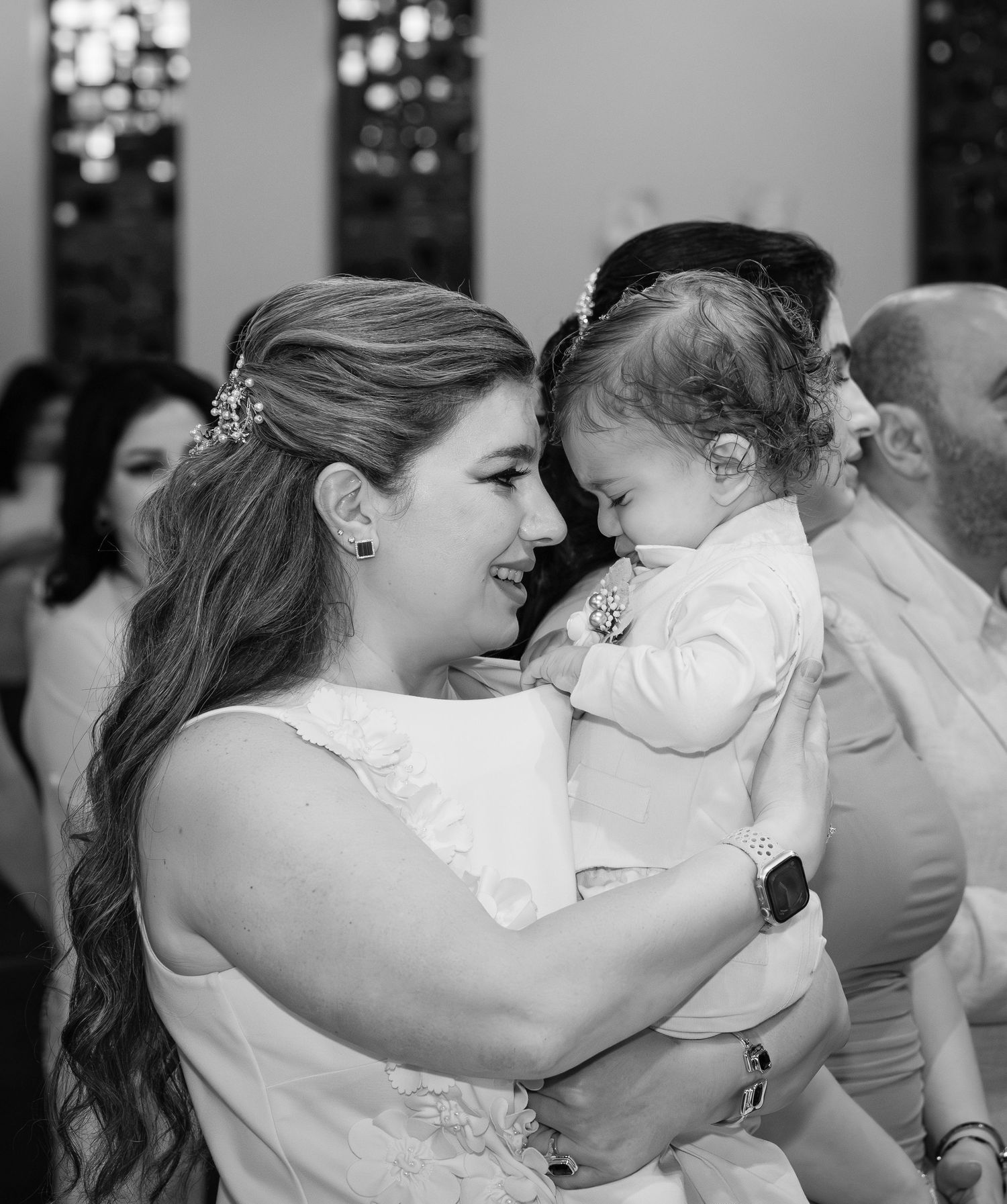 Black and white collage of intimate wedding moments showing couples embracing and sharing romantic kisses.