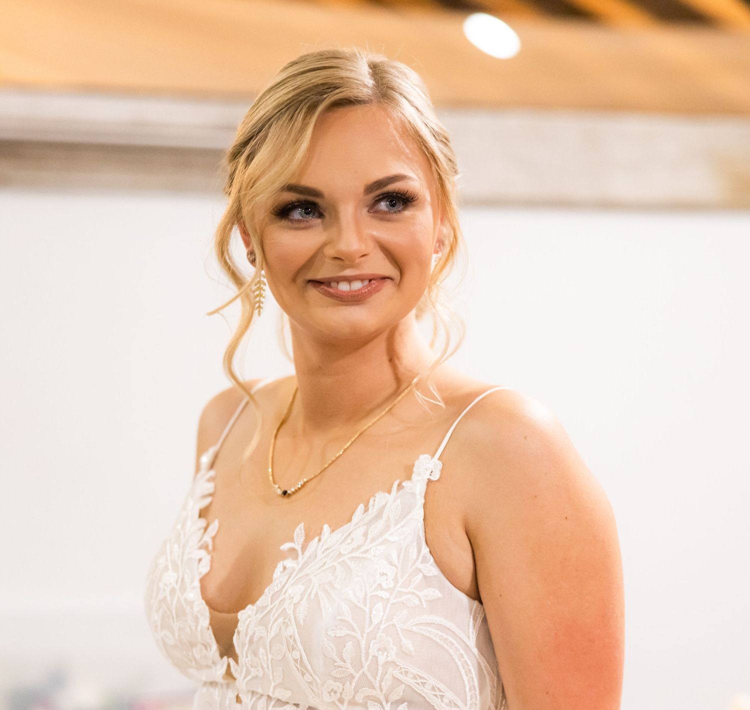 Candid bridal portraits showing joyful expressions in warm indoor lighting.
