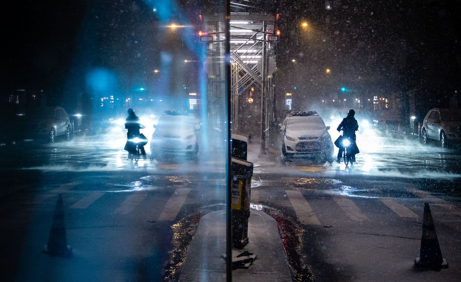 Reflections of a delivery cyclist moving through snow on a dark city street.