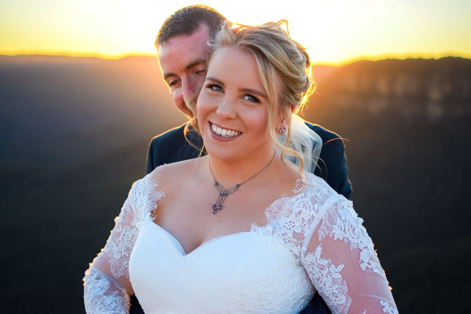 Romantic sunset wedding photos capture intimate moments between newlyweds in golden hour lighting.
