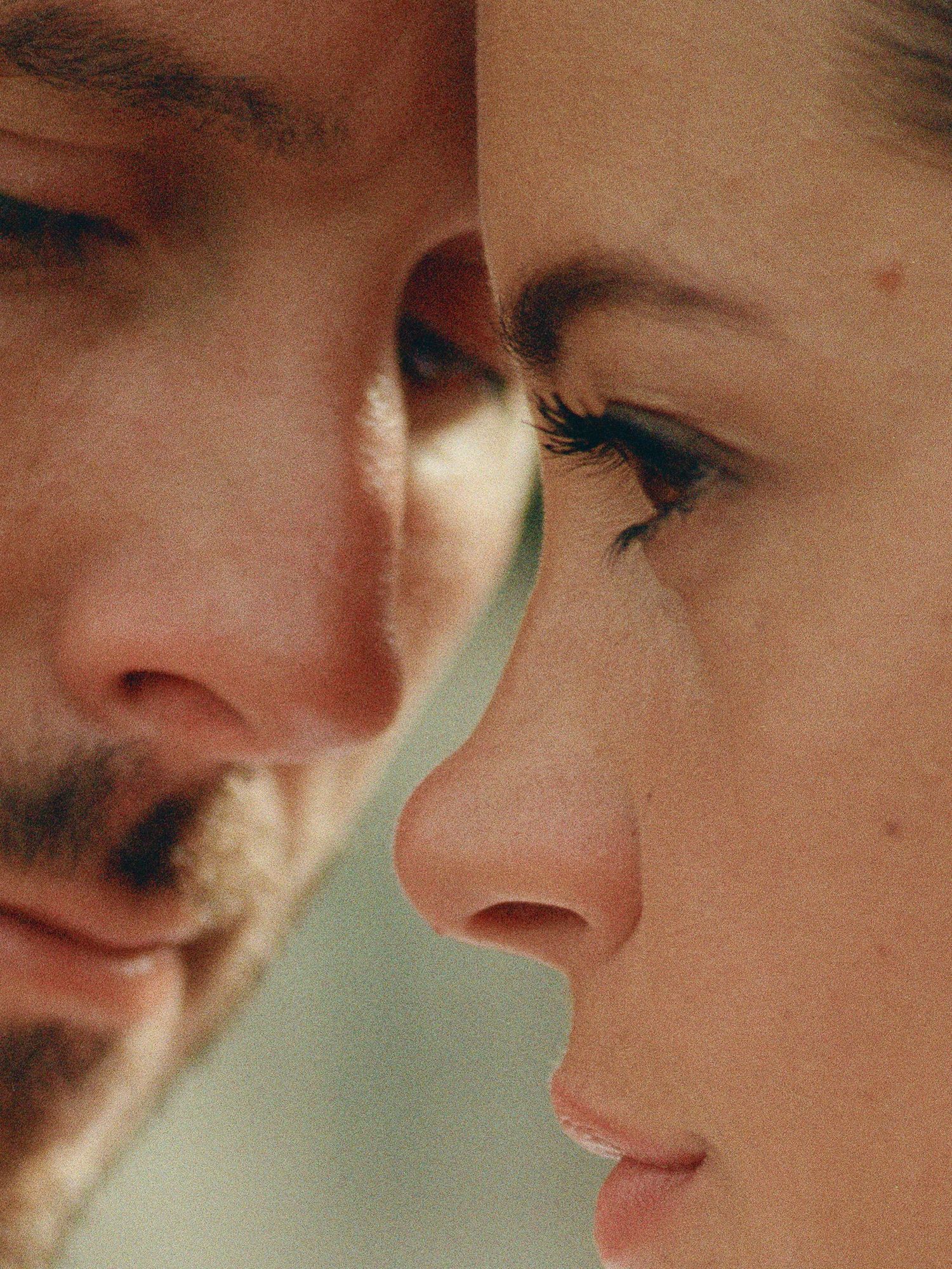 Intimate close-up profile portrait of a bride and groom facing each other.