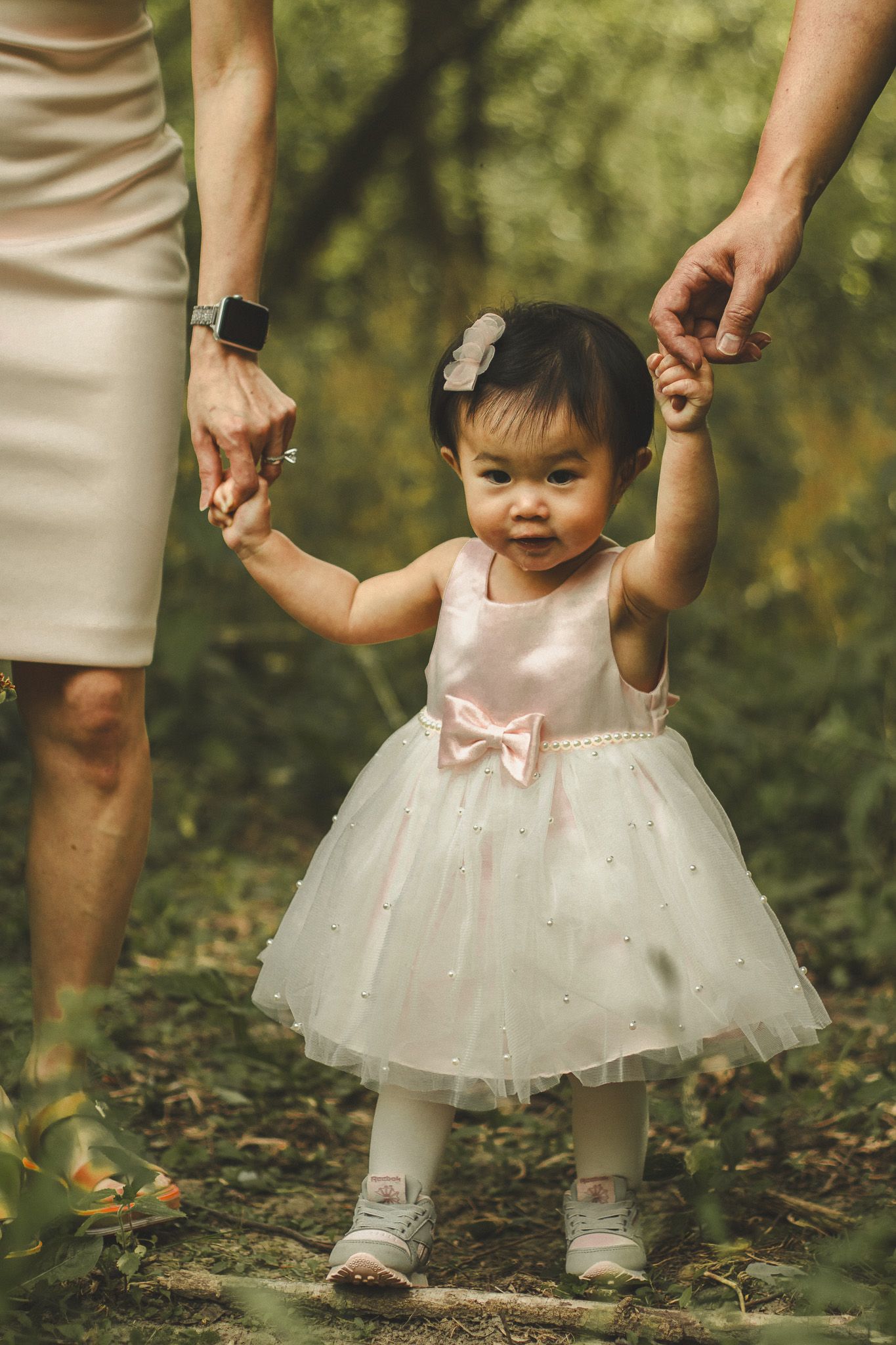 Family photography in Toronto of parents and their daughter, natural landscape of forest