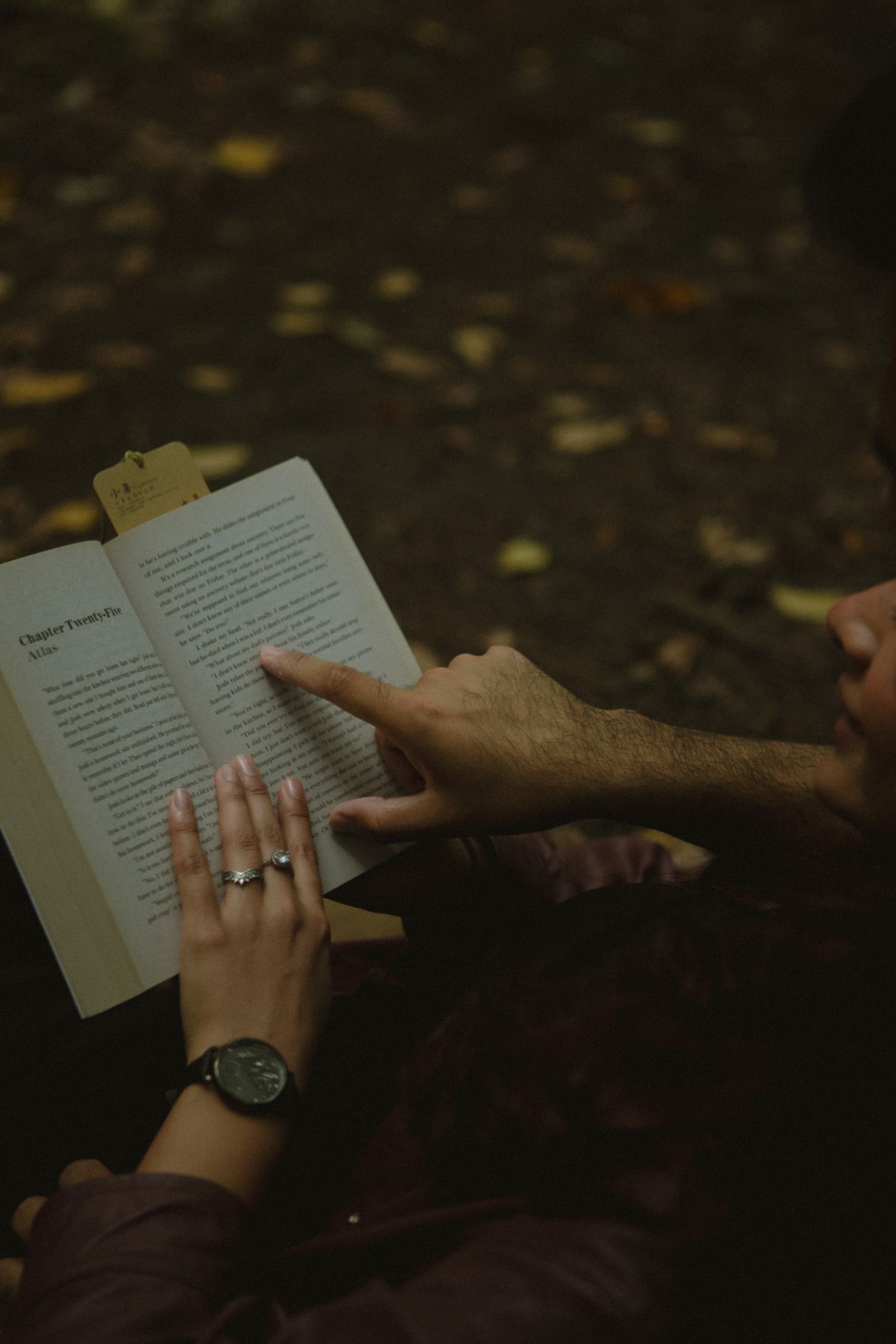 Cinematic documentary-style couples photography taken outdoors in Ontario, couple reading by a tree