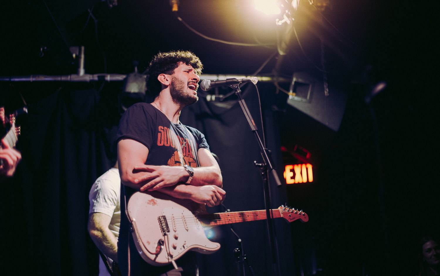 Concert candid photography, vocalist with electric guitar