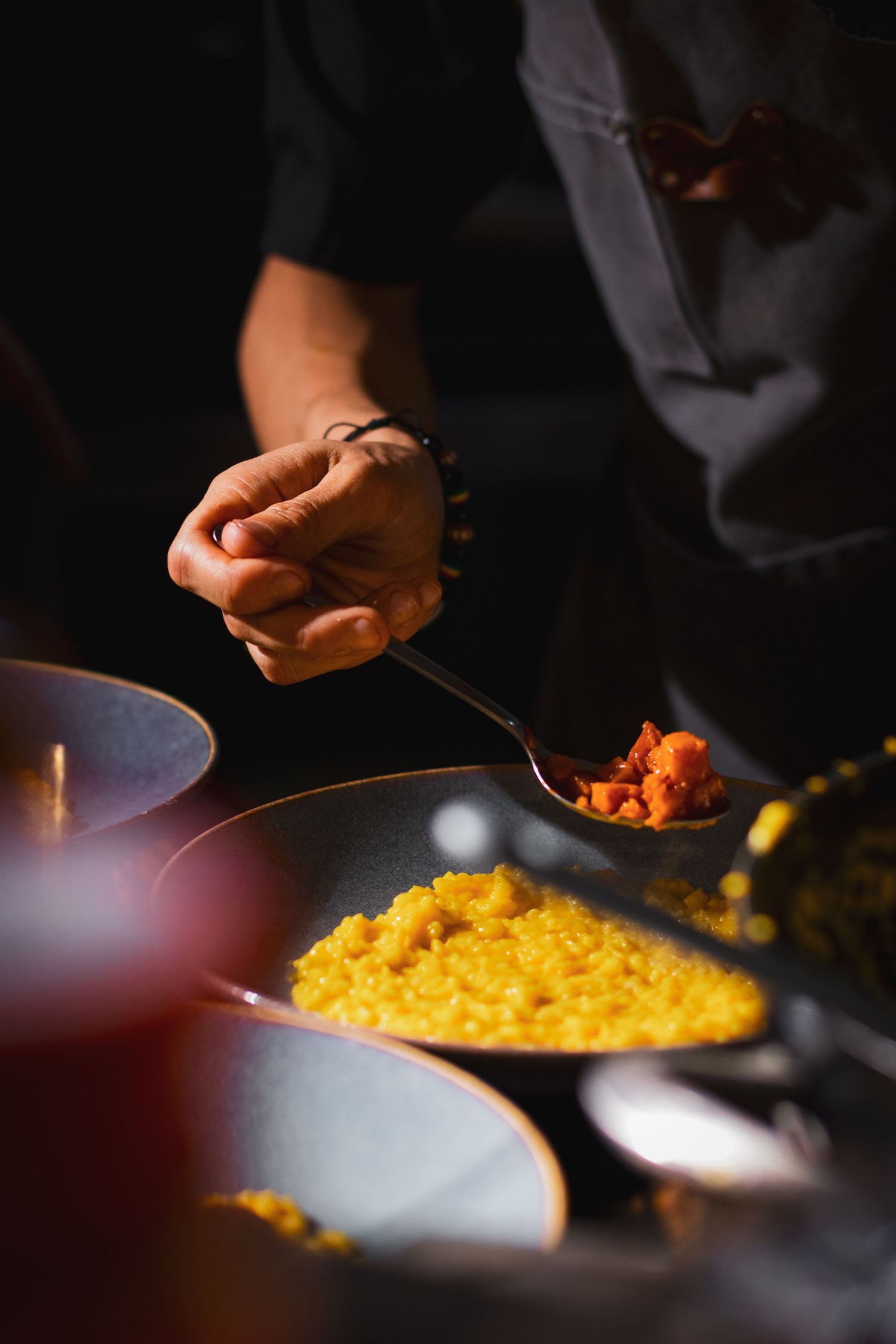 Food photography for tasting menu, clean style, chef putting finishing touches on dish