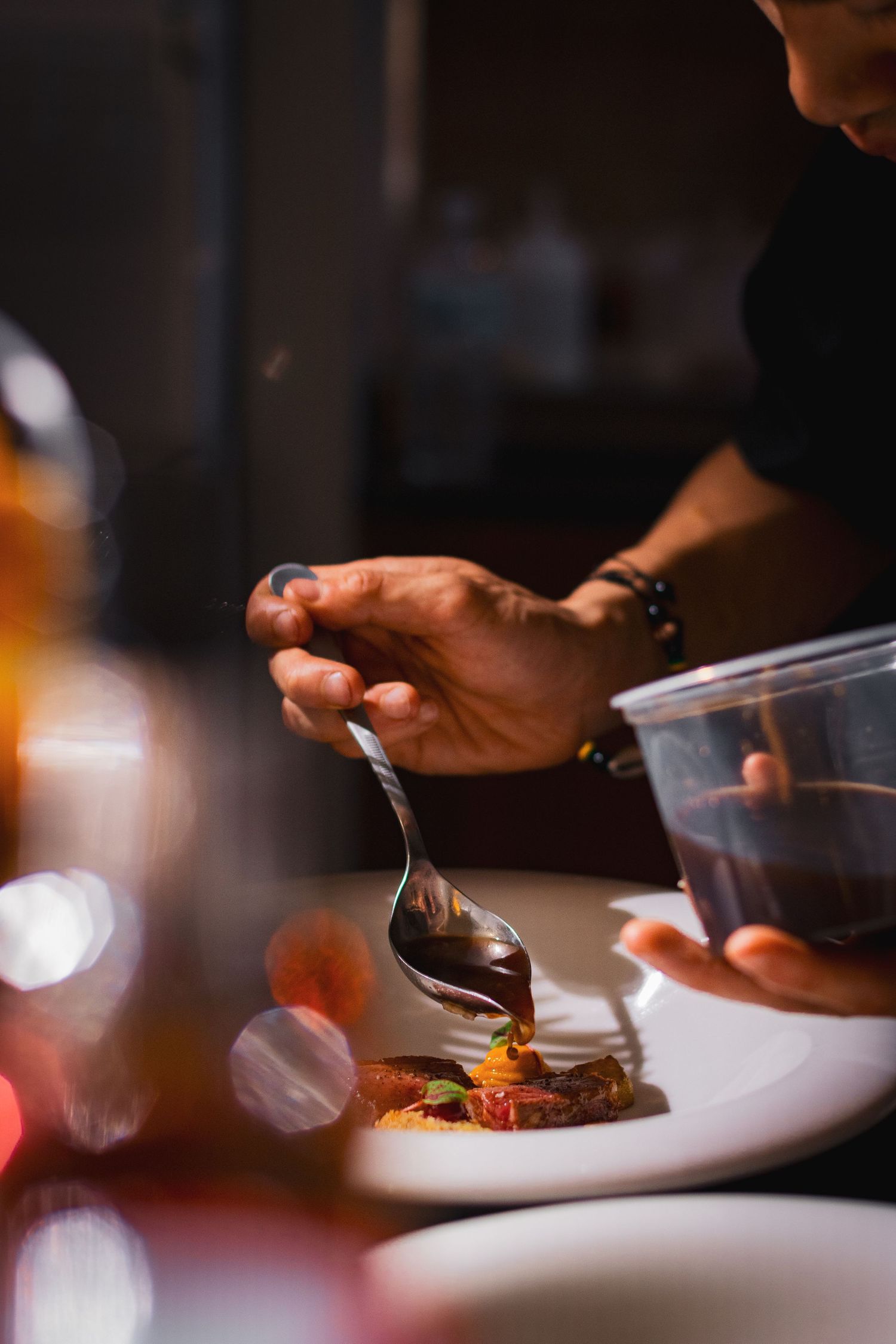 Food photography for tasting menu, clean style, chef putting finishing touches on dish