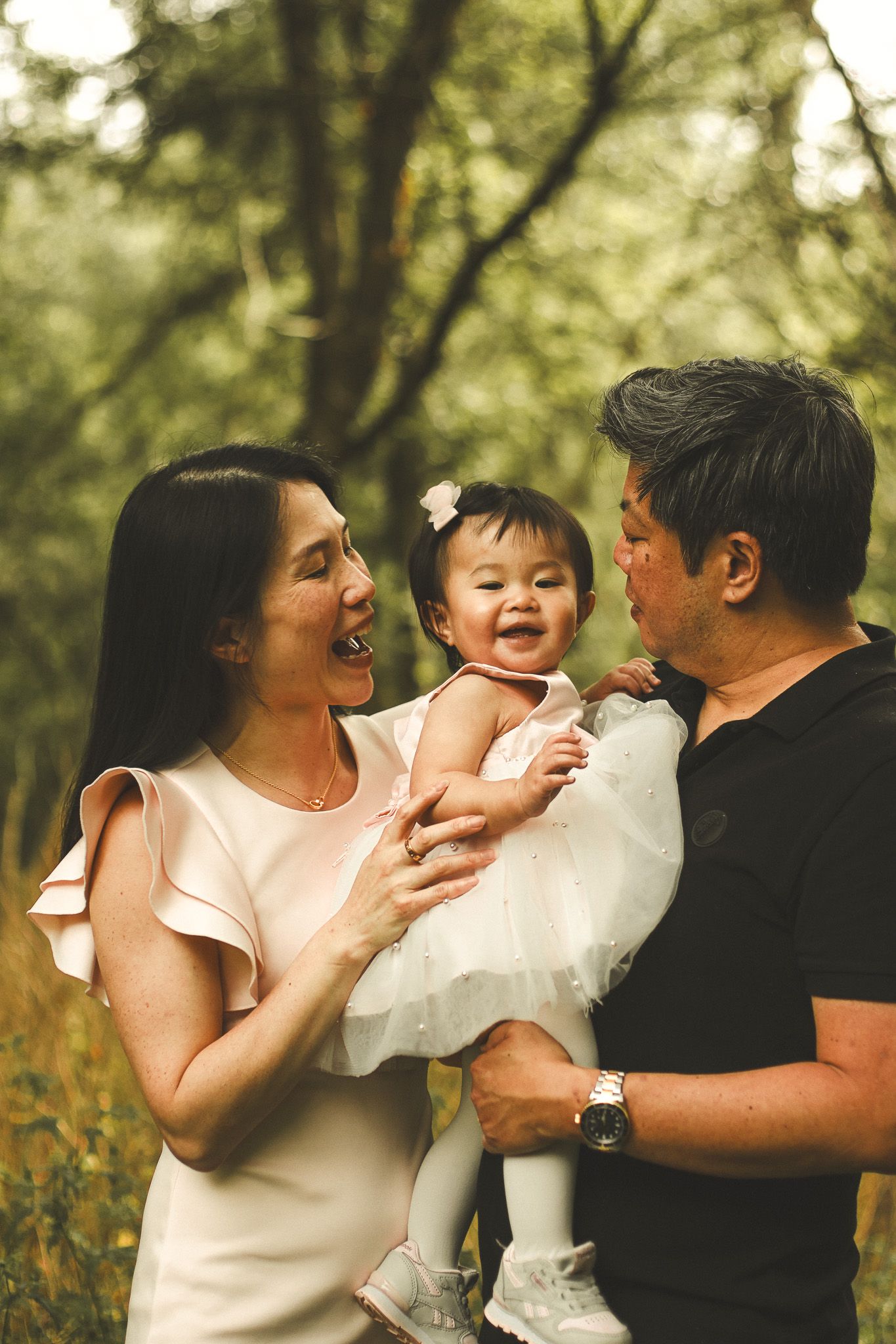 Family photography in Toronto of parents and their daughter, natural landscape of forest