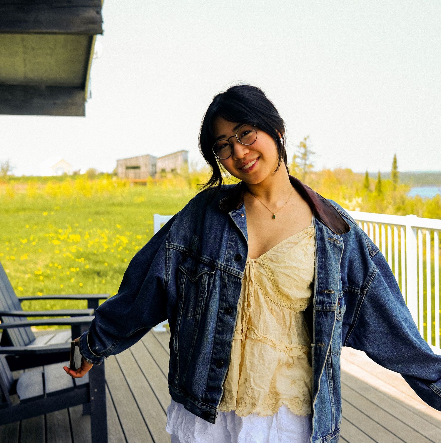 Standing on cottage deck, denim jacket