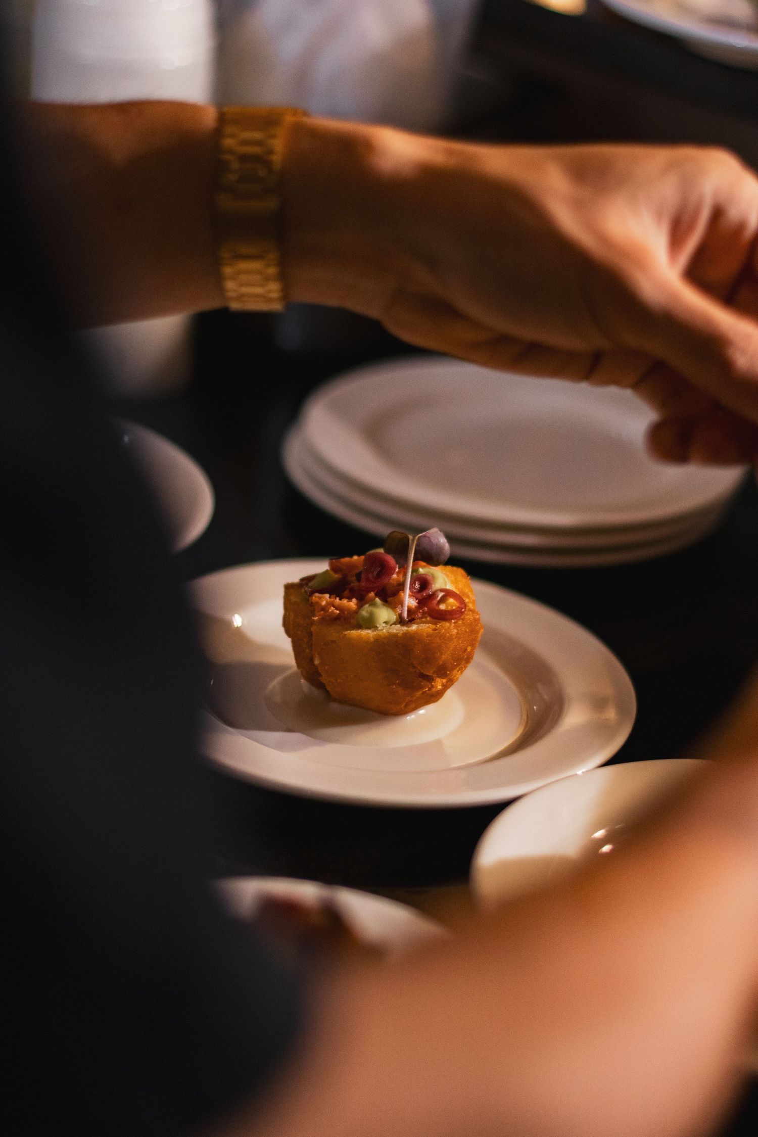 Food photography for tasting menu, clean style, chef putting finishing touches on dish