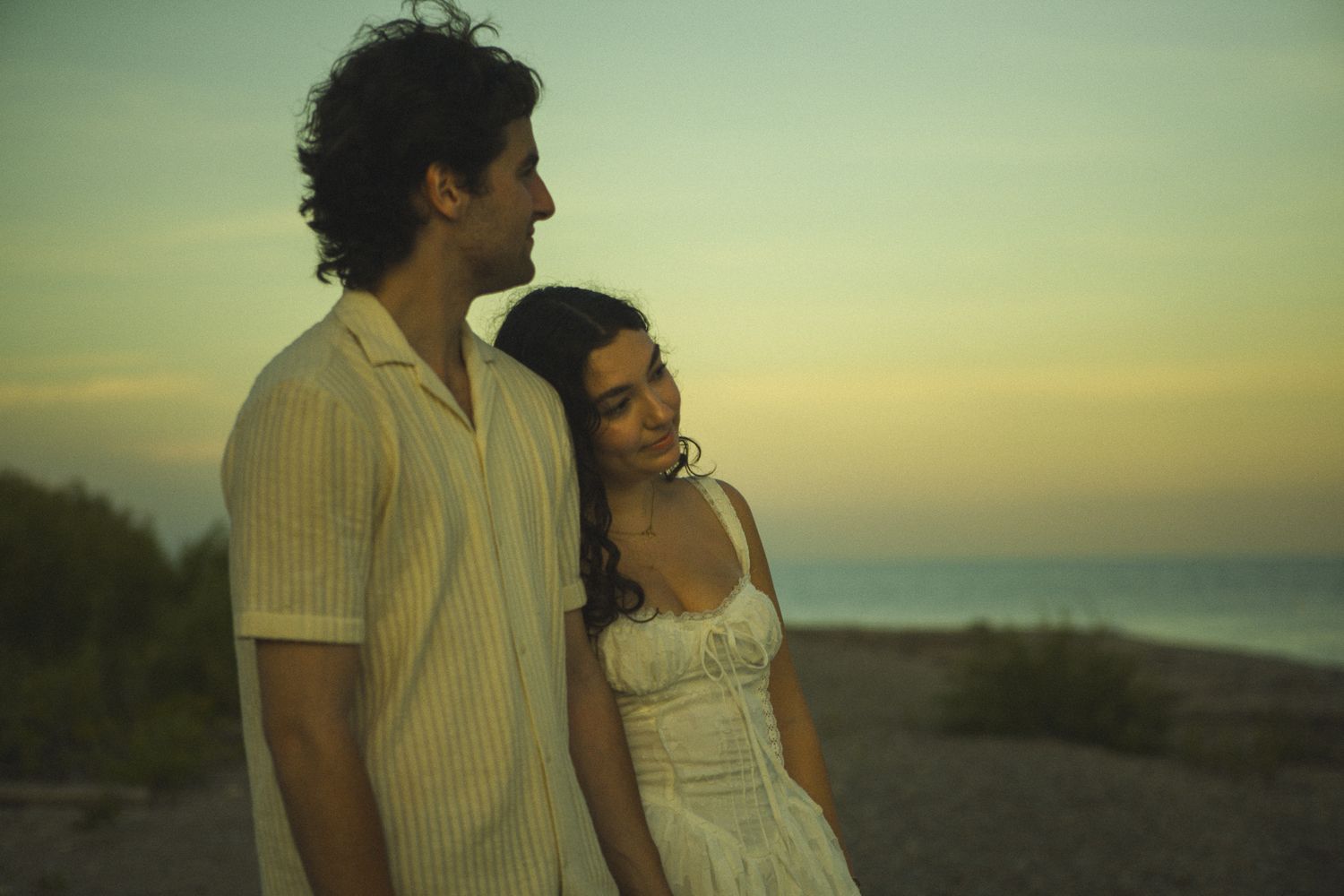 Cinematic documentary-style couples photography taken in Toronto nature, candid and emotional interaction, beach