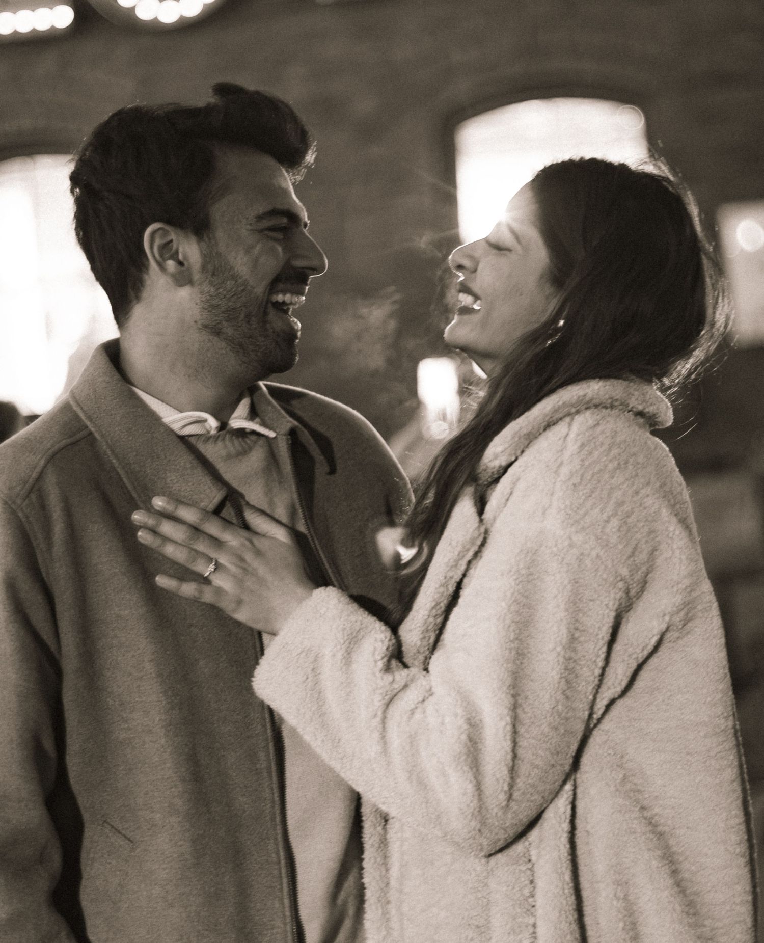 Post engagement candid portrait of couple laughing, toronto