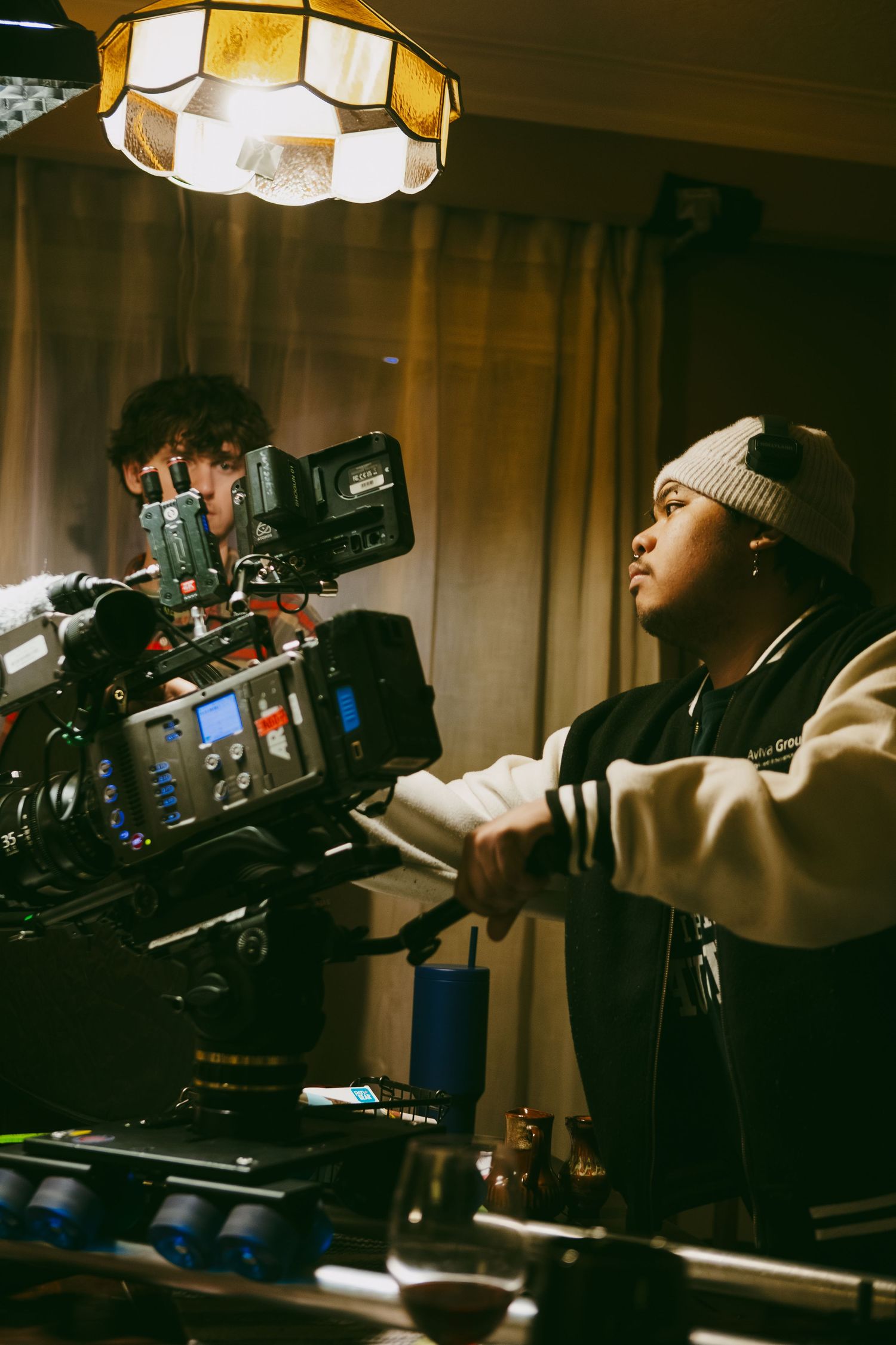Film set BTS photo of candid moment, cinematographer in BROCCOLI LAW 2026