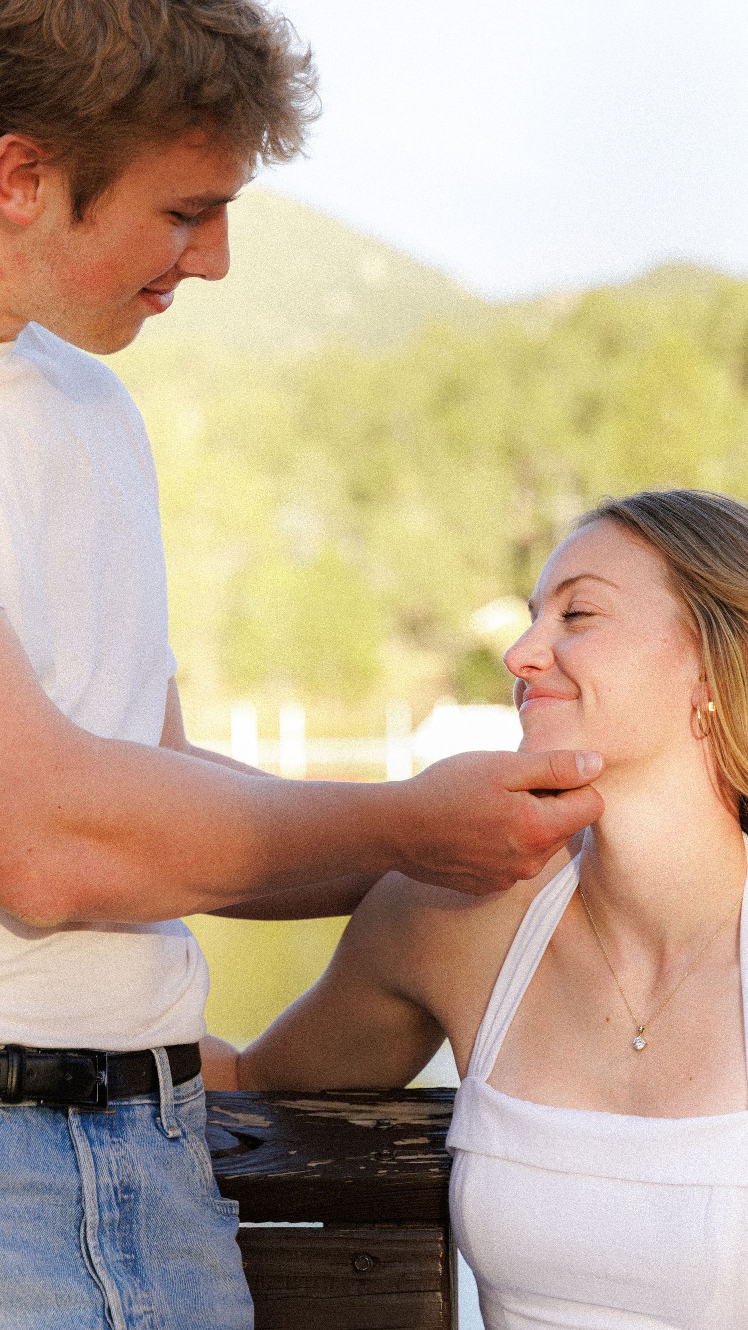Evergreen Colorado engagement, close up on the couple as he strokes her chin