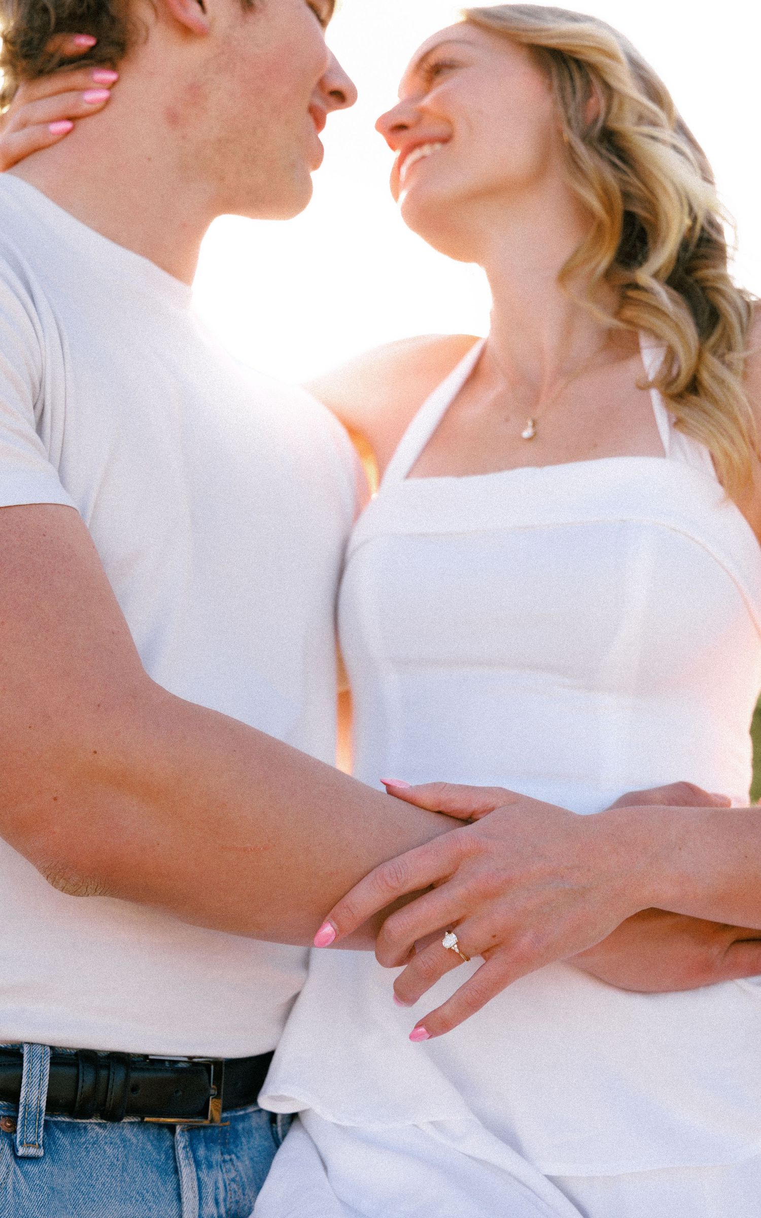 Engaged Couple Sharing a Sunlit Moment in Evergreen, Colorado