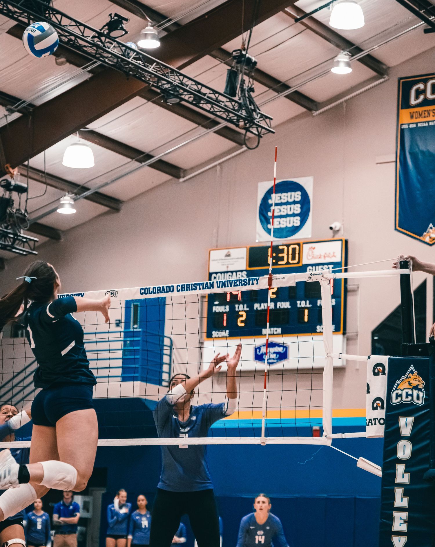 CCU Cougars Volleyball Spike Near the Scoreboard