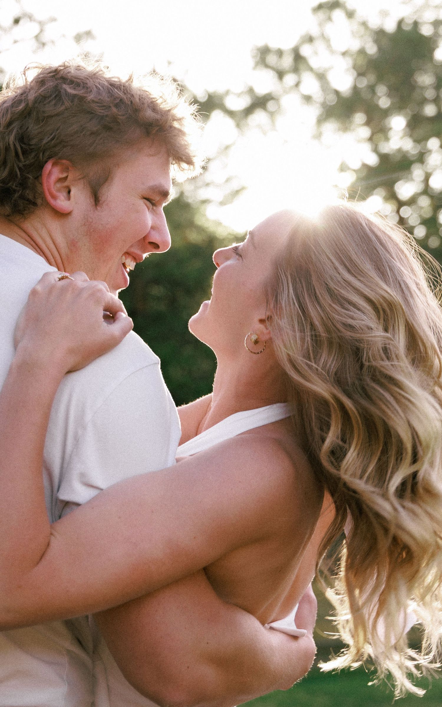 Evergreen Colorado engagement, laughing into the sunlight at each other moments