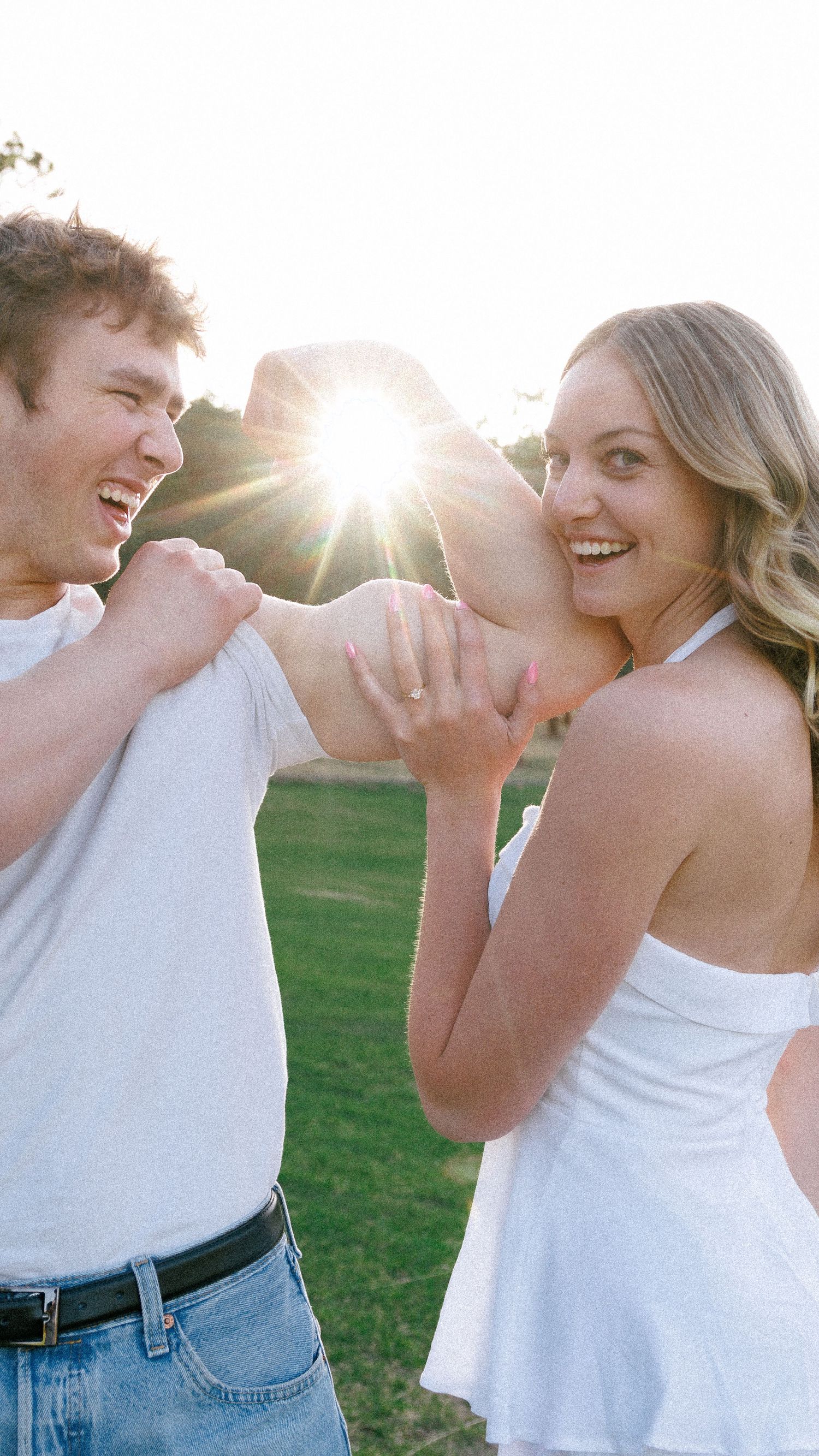 Evergreen Colorado engagement, flexing while she holds onto his arm poses
