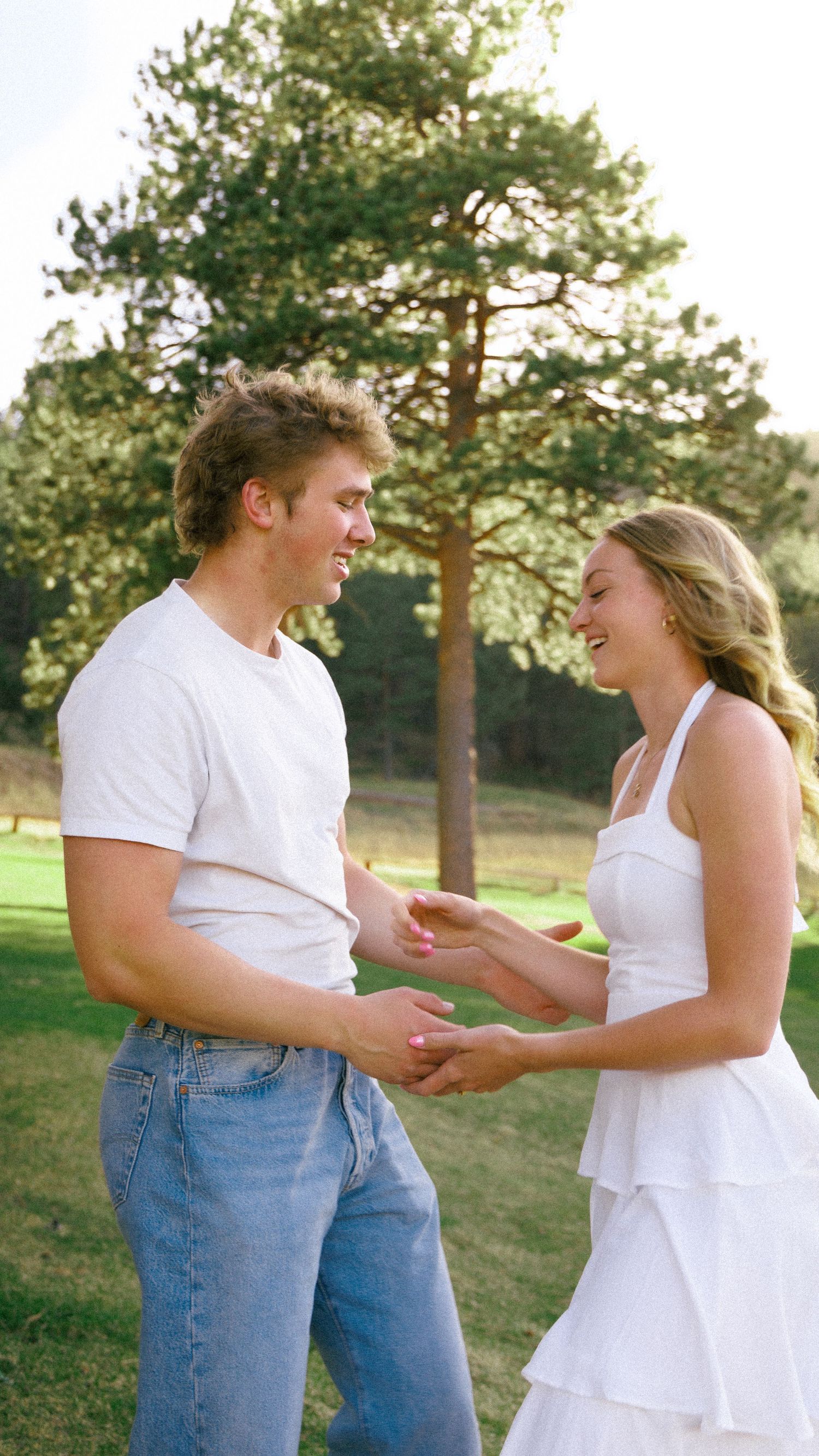 Twirling Engagement Photo in a Colorado Pine Meadow