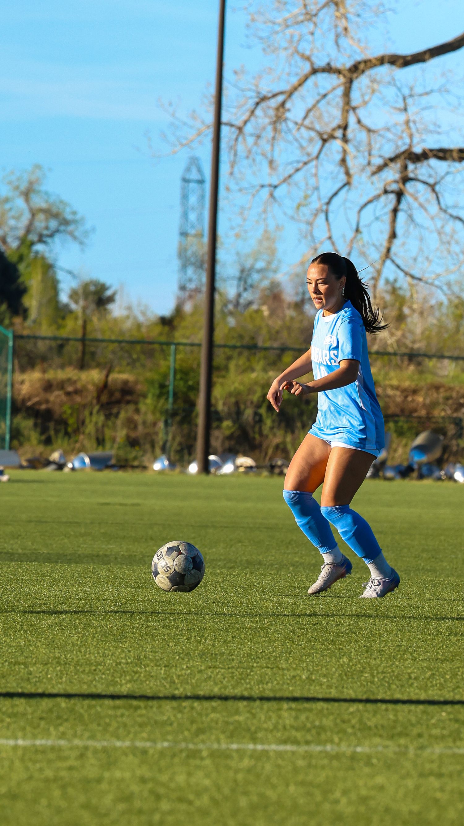 CCU Cougars Player Controls the Ball Under Blue Skies
