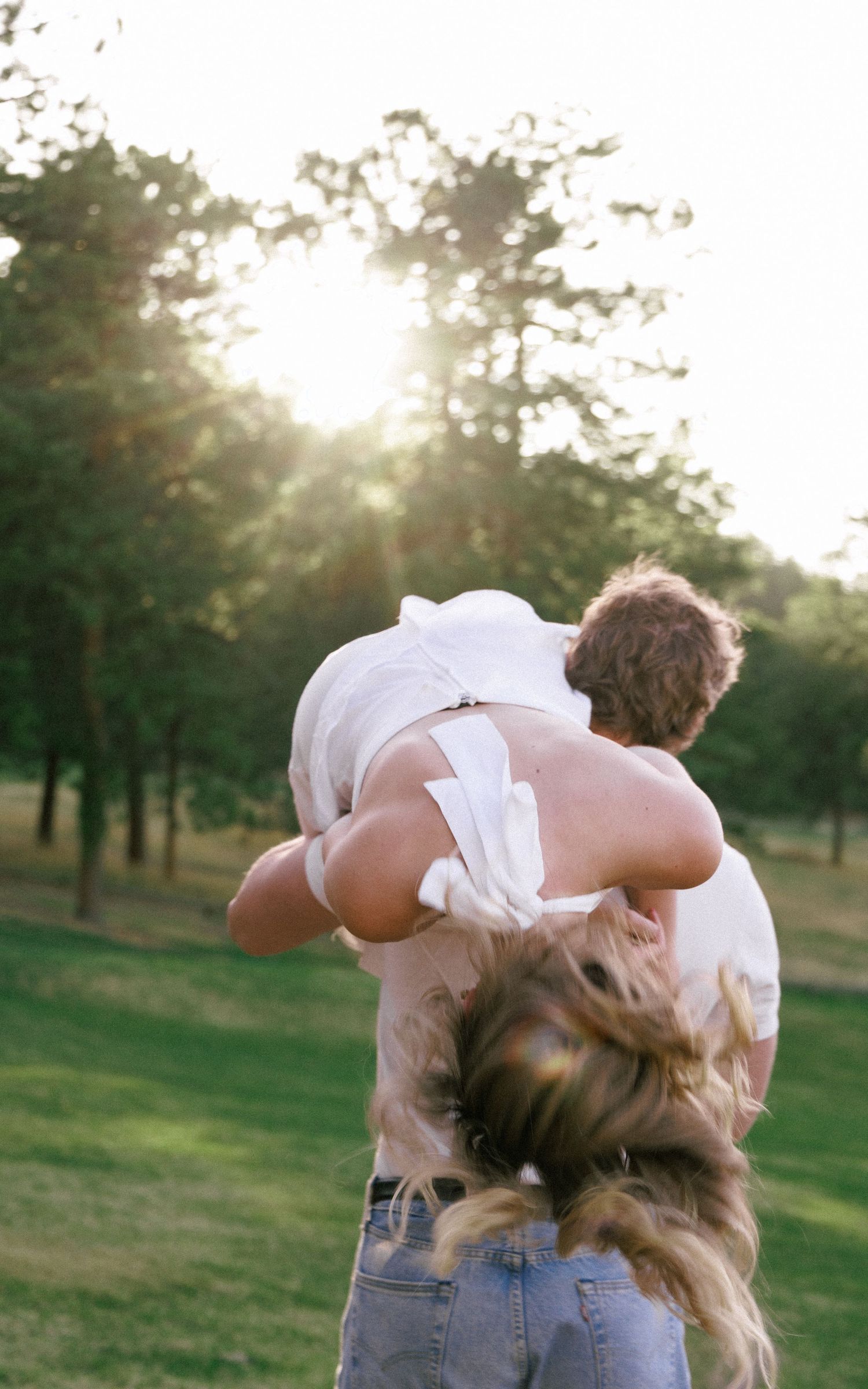 Evergreen Colorado engagement, over the shoulder in a meadow