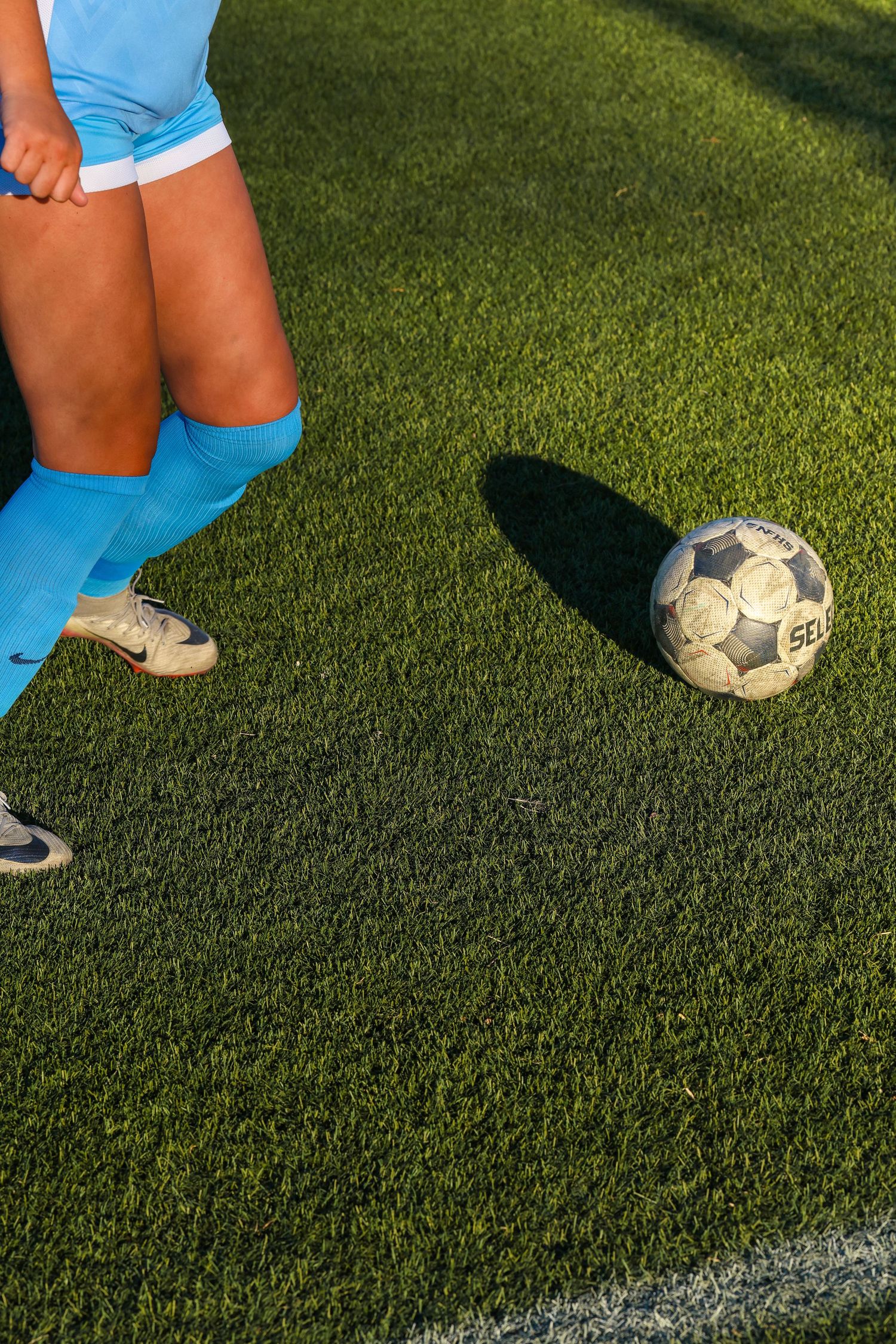 CCU Cougars Soccer Ball and Player Legs on Turf