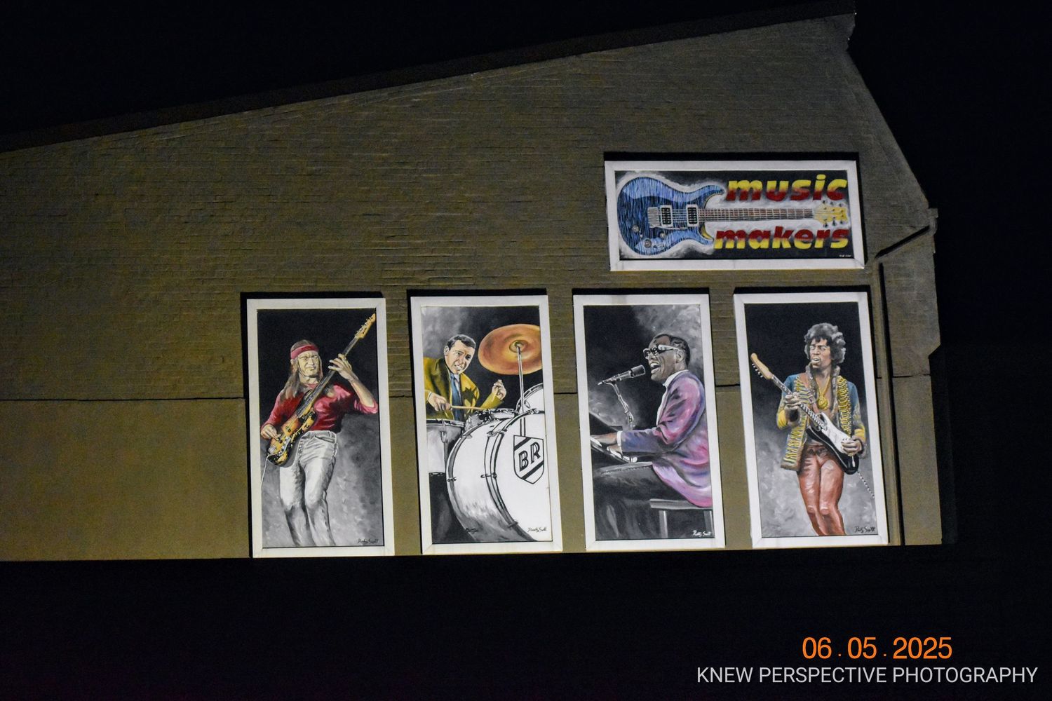 Four vintage rock and roll performance murals displayed on the exterior wall of Music Makers.