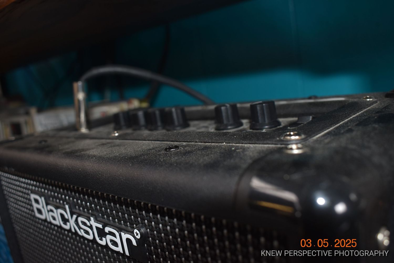 Close-up view of professional audio equipment and mixing console controls in dark lighting conditions.