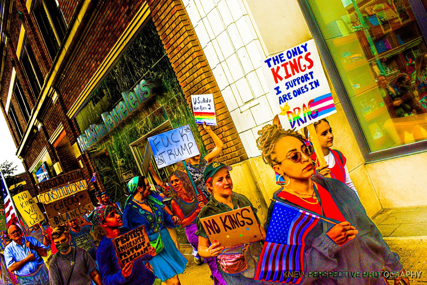 Colorful posters held by protesters in a vibrant display of artistic expression.
