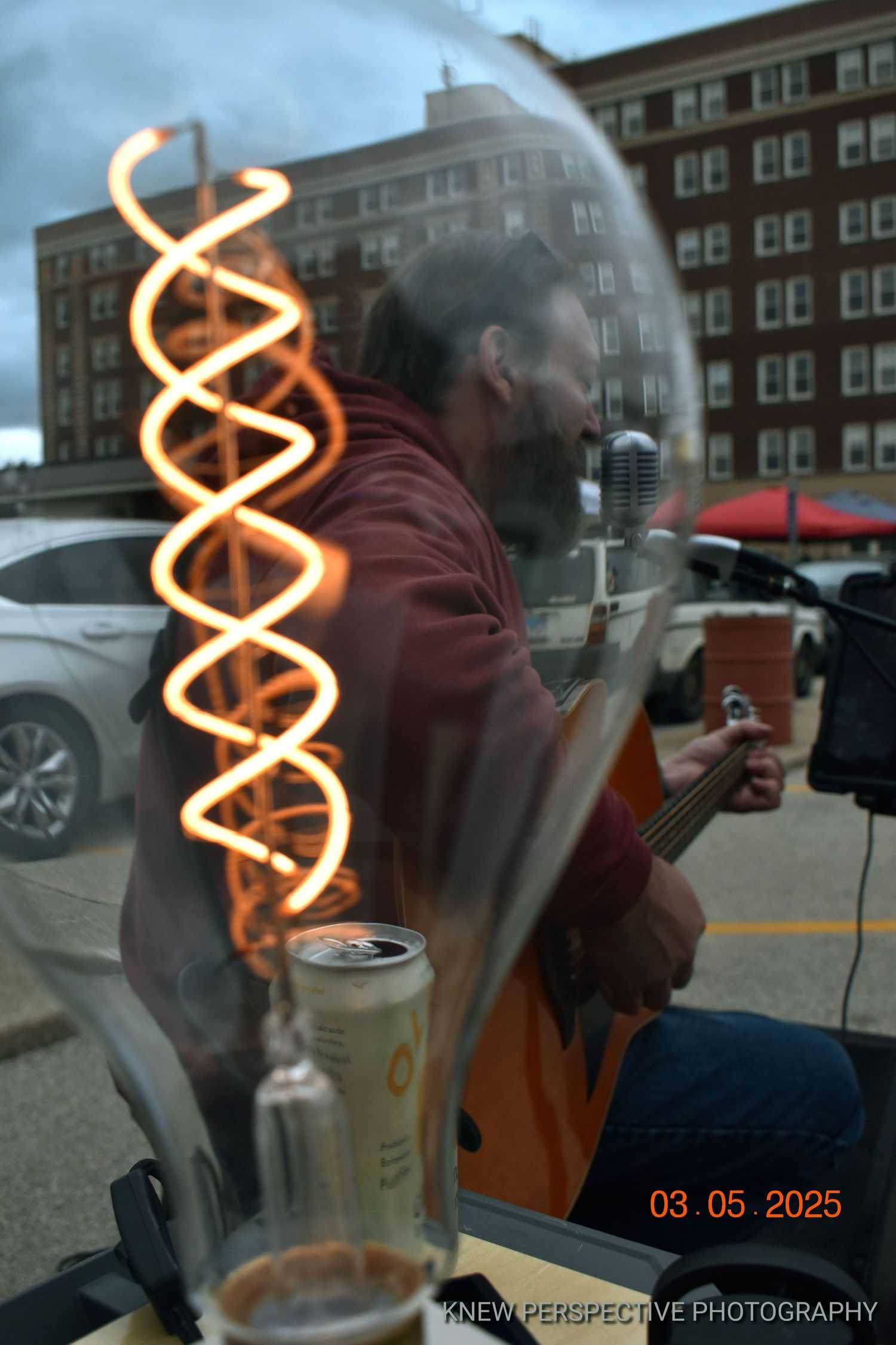 Portrait of a musician shit through a light bulb with an LED spiral.