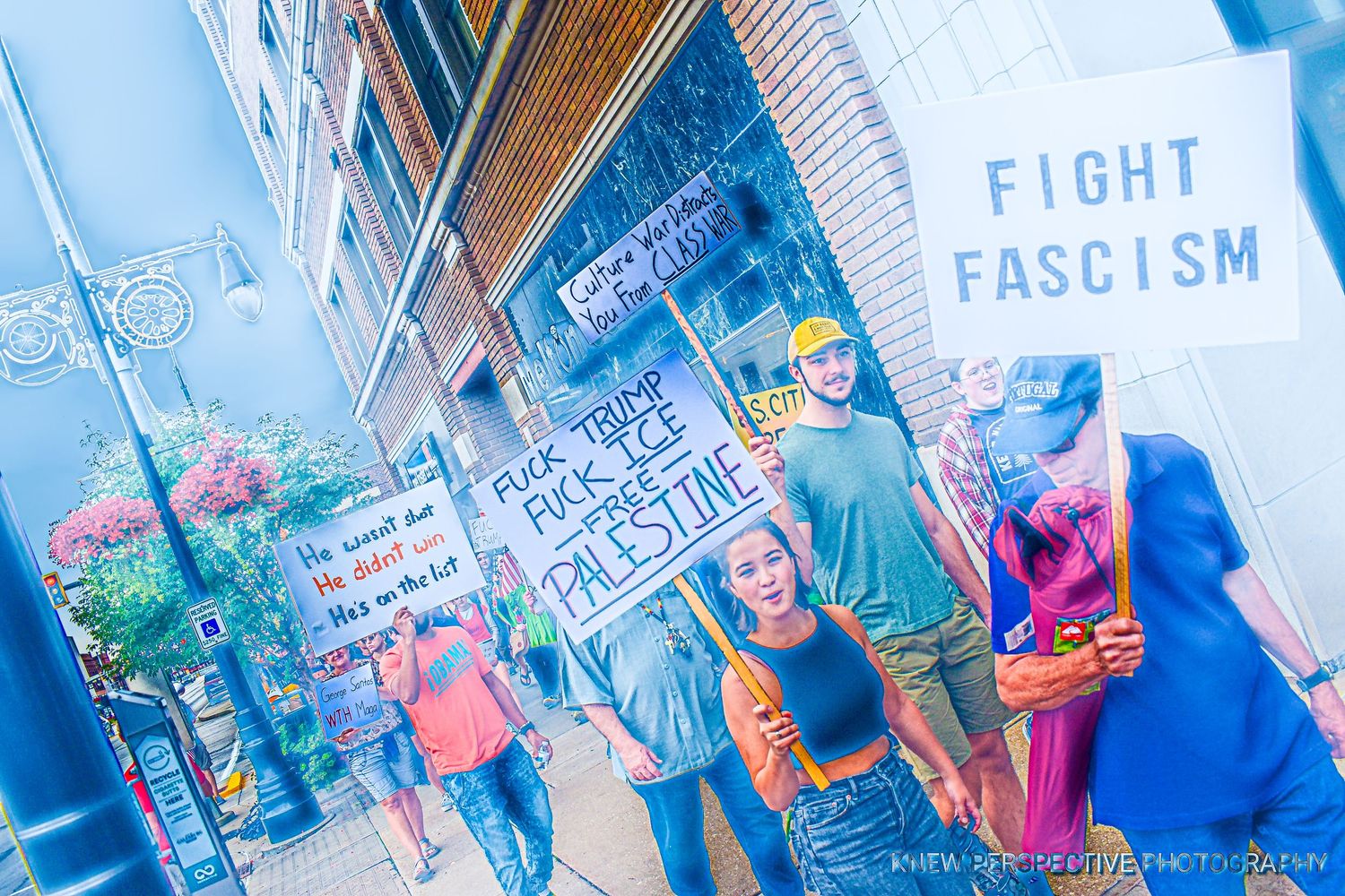 Protest signs and banners with anti-fascism messages held up at a political demonstration.