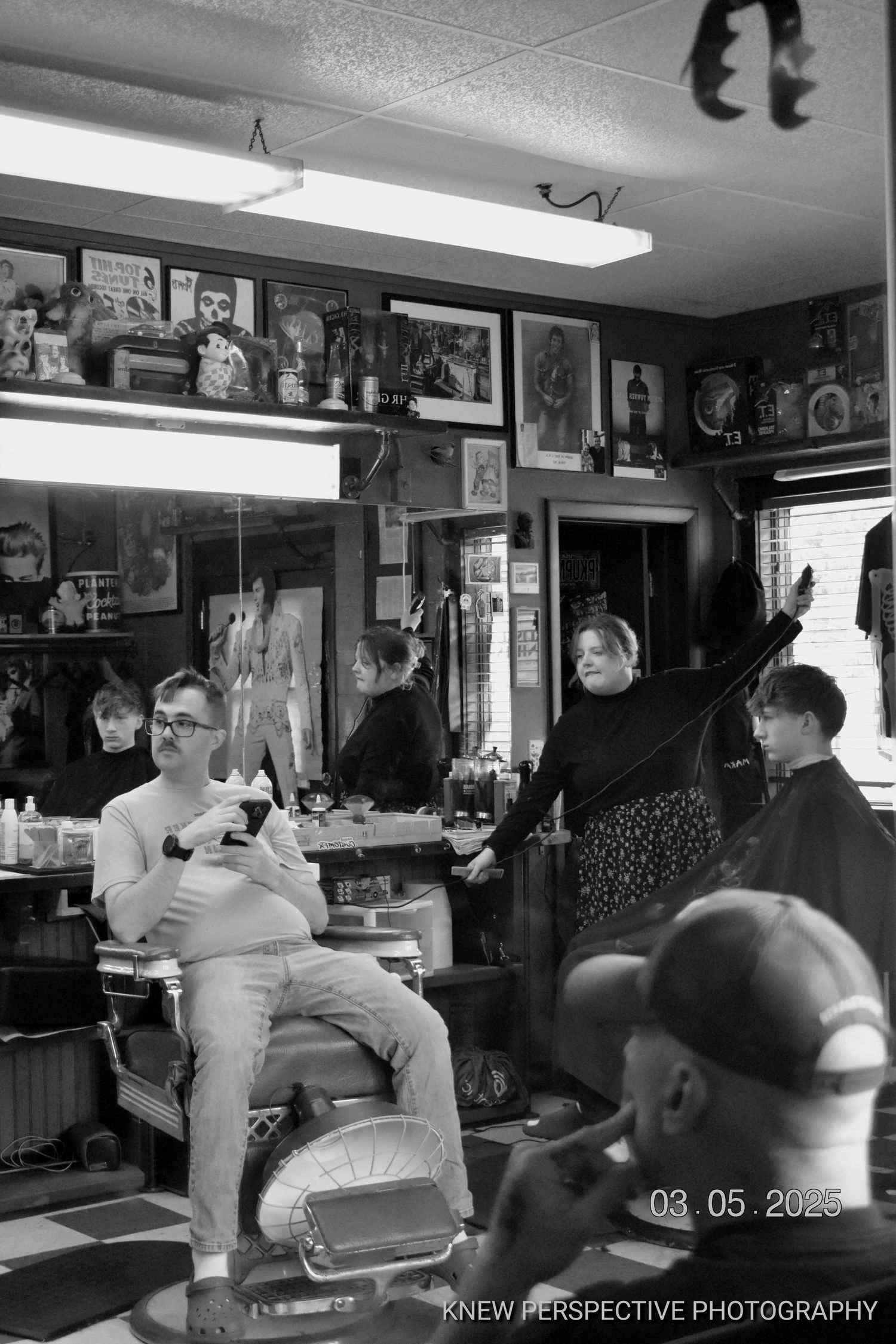 Black and white photo sequence showing customers and staff inside a busy barbershop with vintage decor and mirrors.