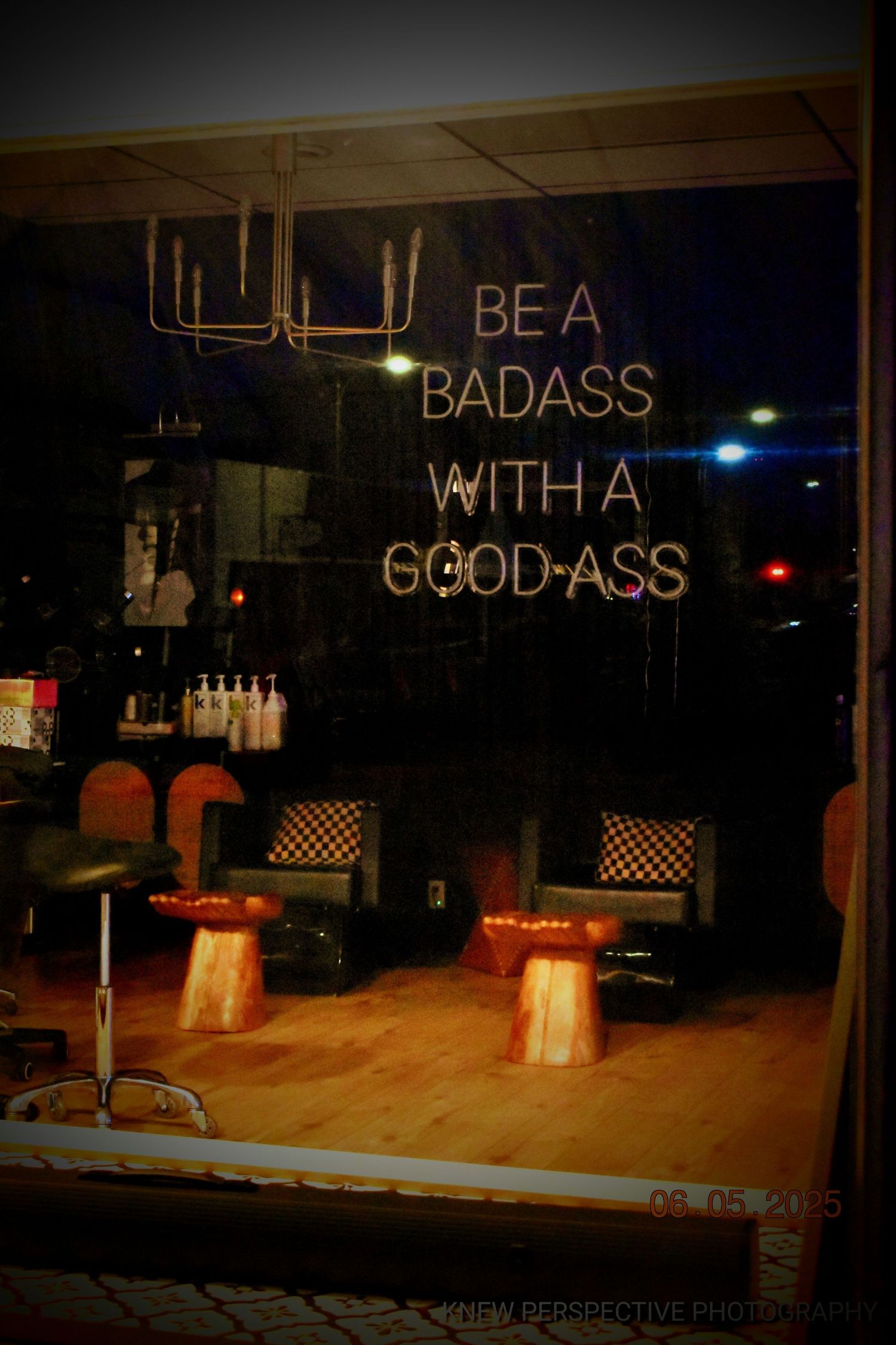 Dimly lit stage area with neon text signs displaying motivational messages in a dark space.