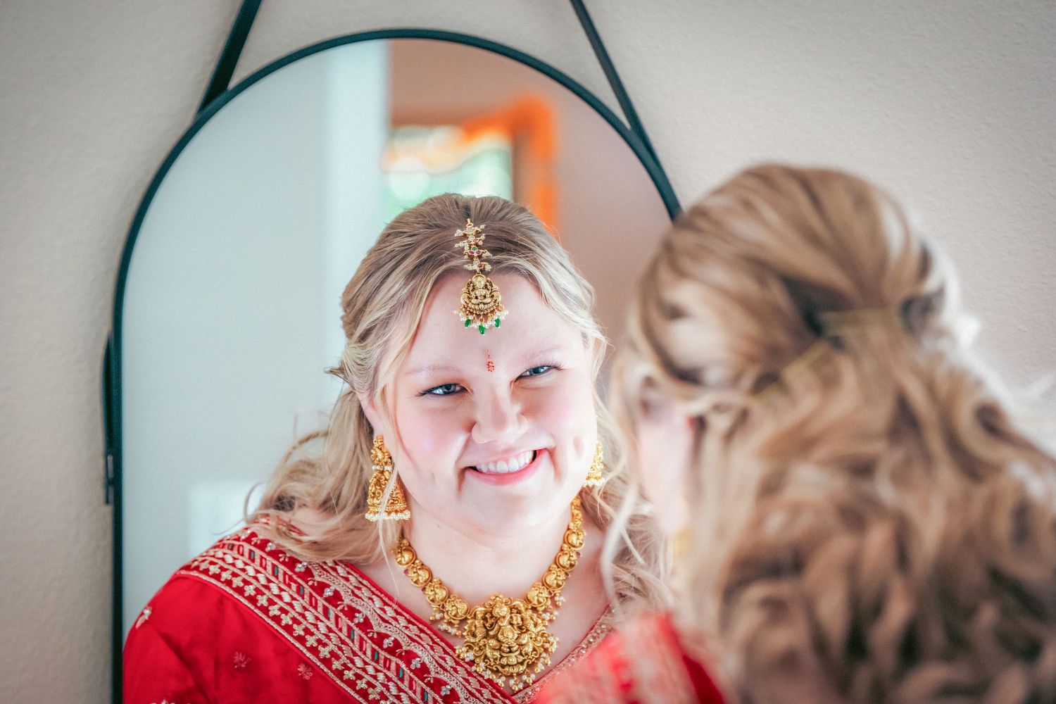 Close-up portrait series showing traditional Indian bridal jewelry and red attire during a wedding ceremony.