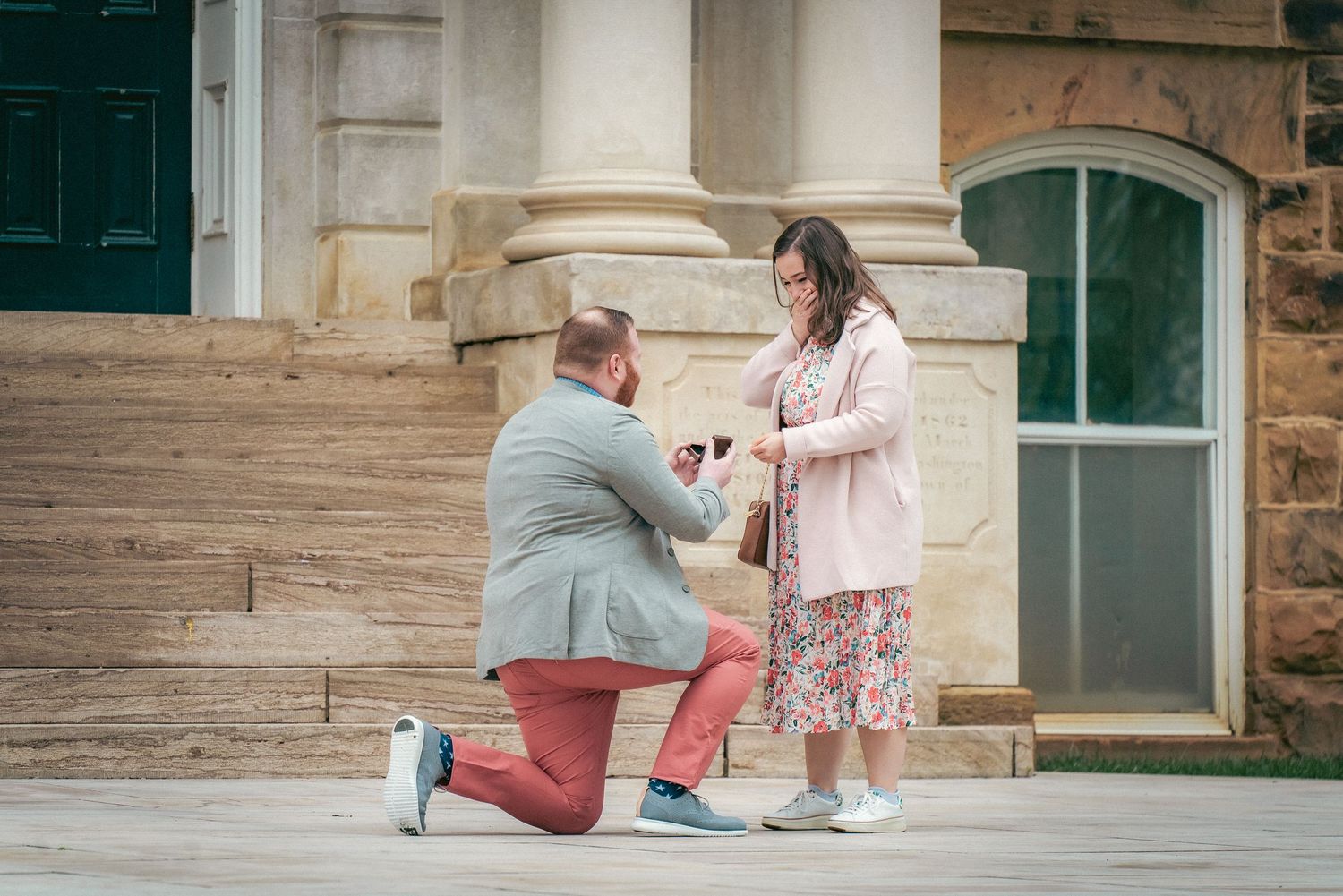 Romantic proposal moment captured on historic stone steps.
