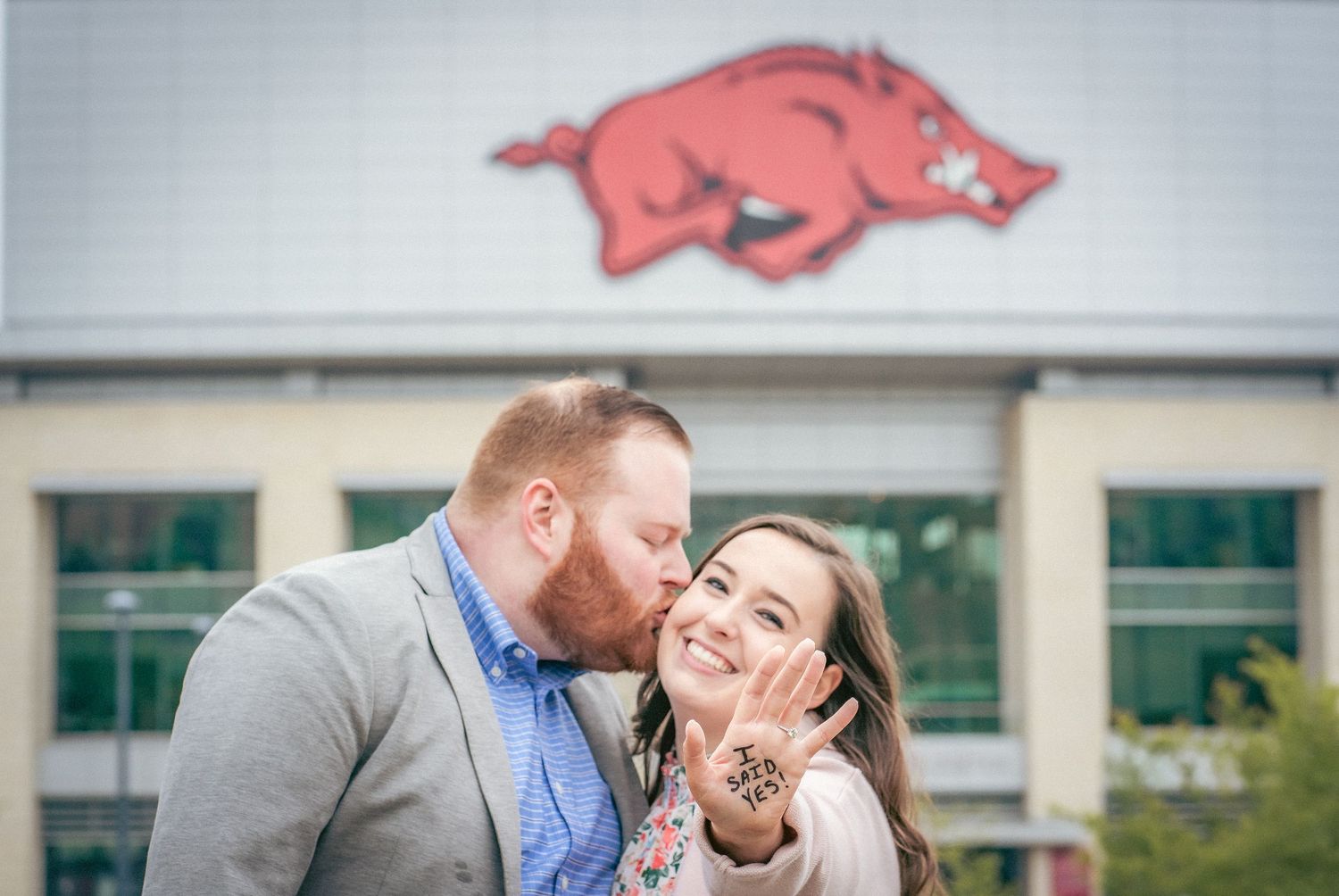 Series of romantic engagement photos with Arkansas Razorback logos in background.