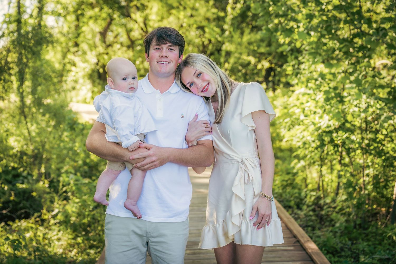 Family candid moments captured in sunlit outdoor setting.