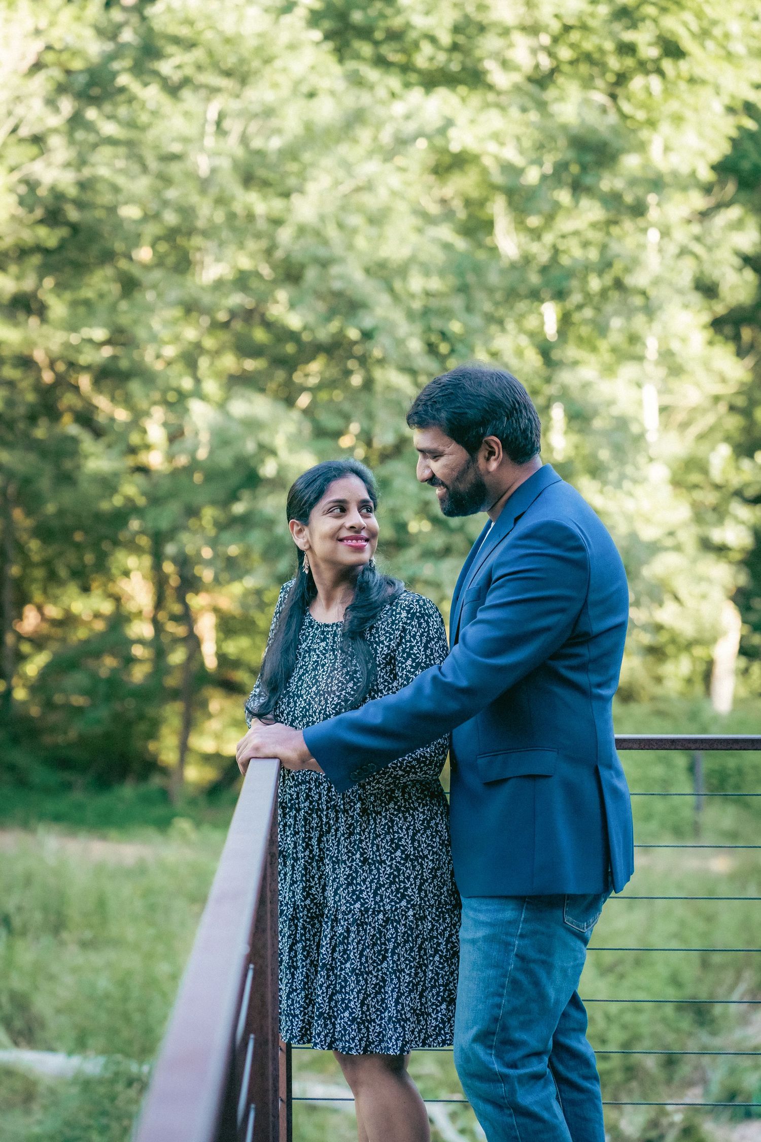 Romantic couple shares candid moments together on an outdoor deck.