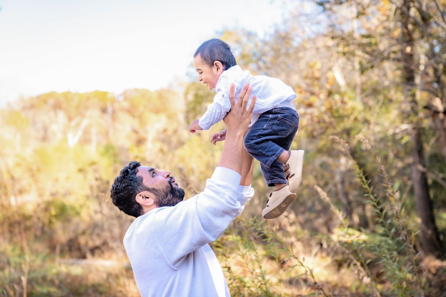 Playful moments captured during outdoor autumn photoshoot.