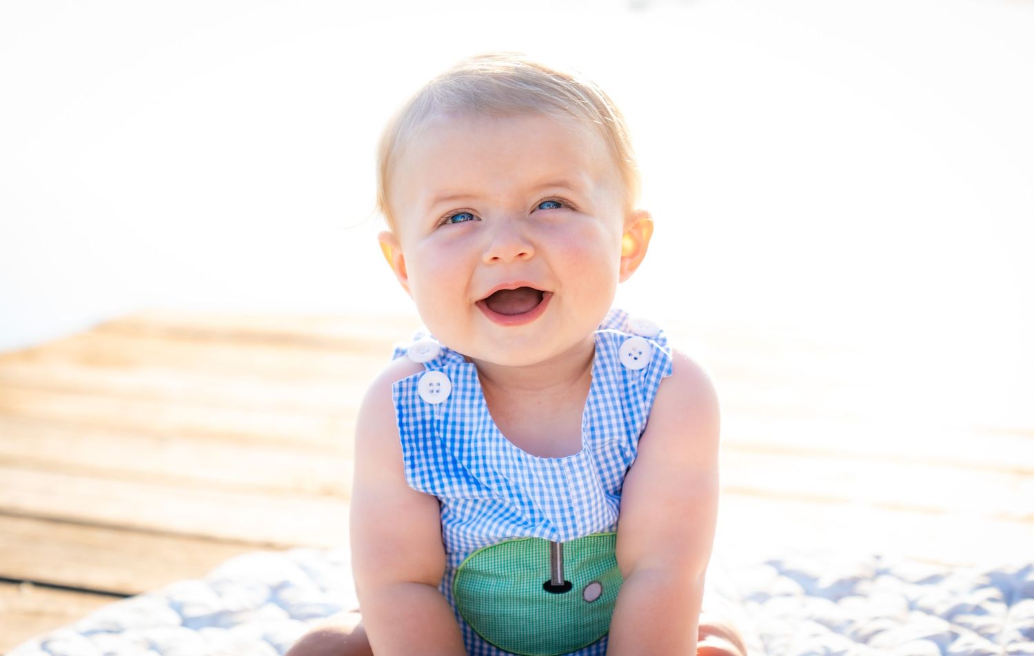 Series of joyful baby expressions in bright outdoor setting.