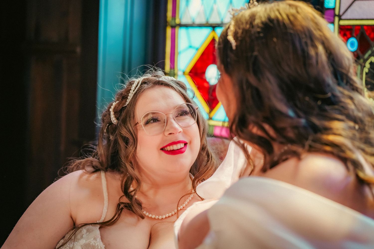 Candid moment of celebration and laughter at an indoor wedding reception.