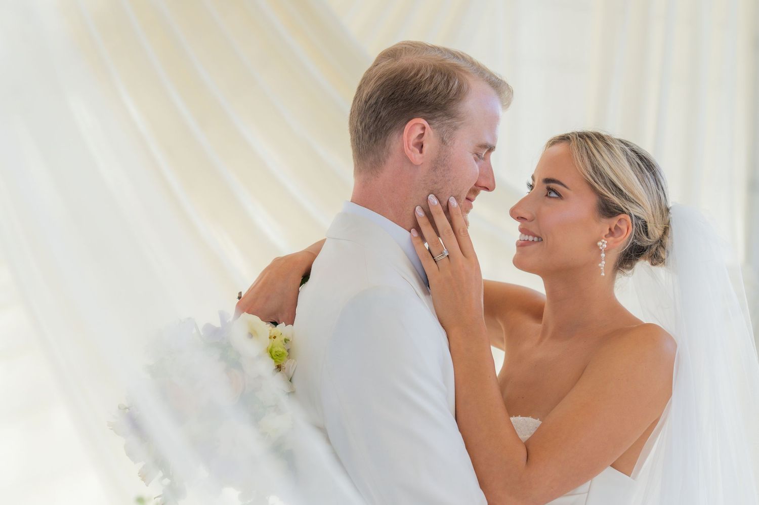A tender romantic moment captured between a couple during their wedding celebration.