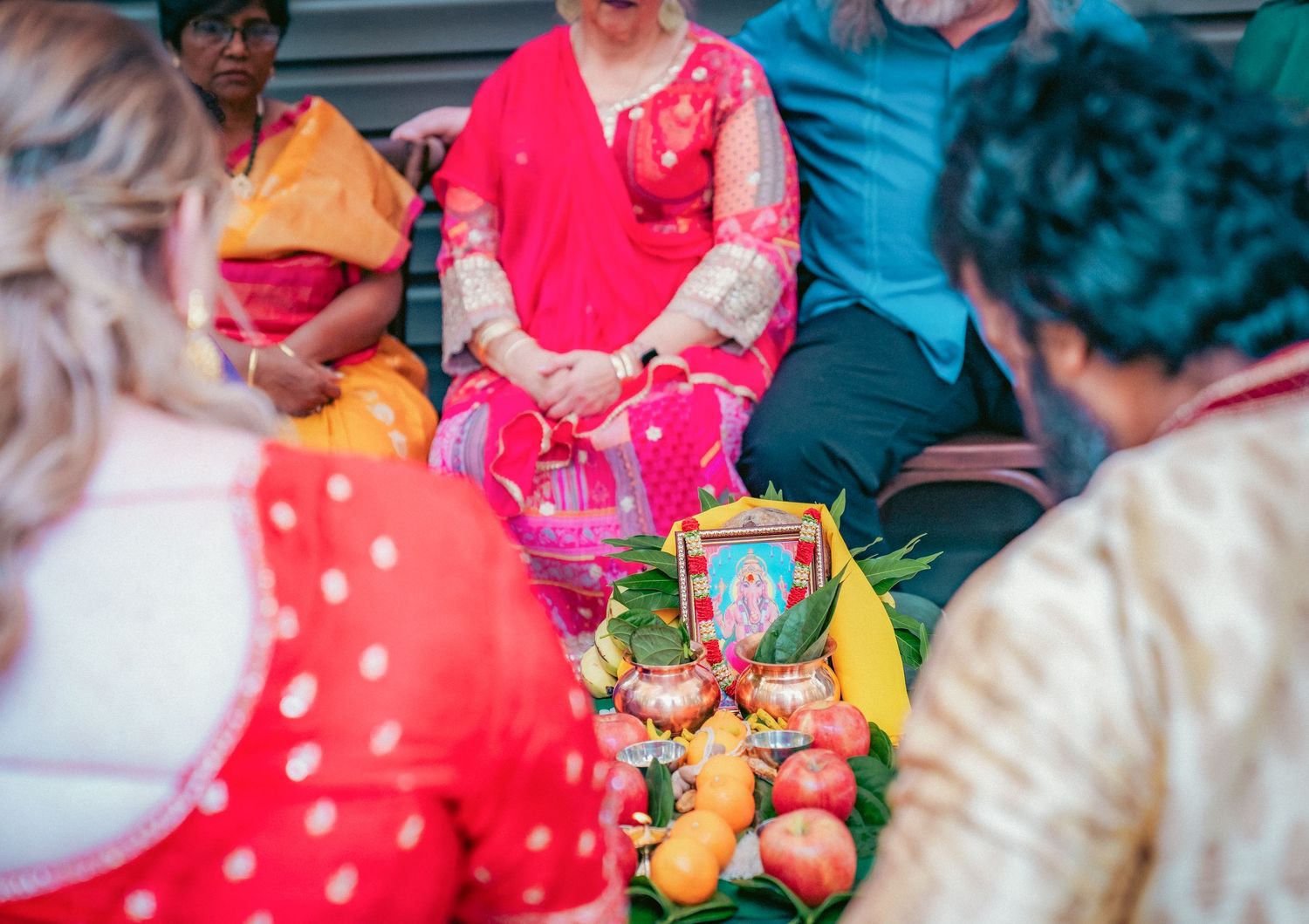 Traditional Indian wedding ceremony rituals being performed with colorful decorations and offerings.
