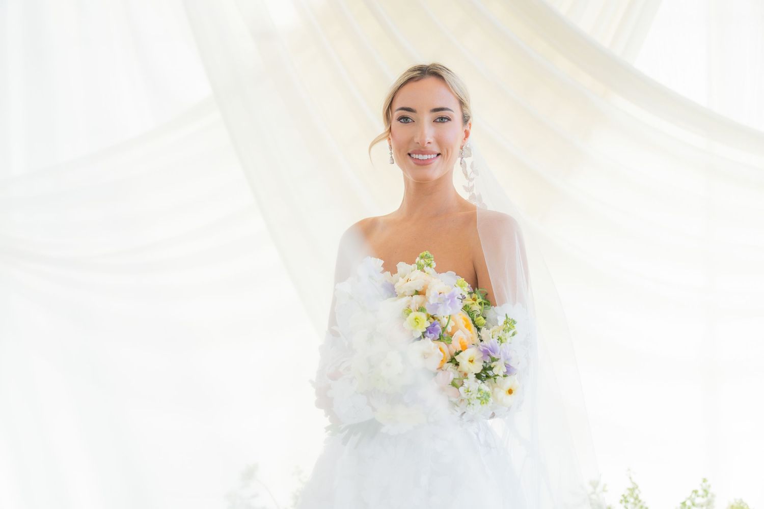 Ethereal bridal portrait with soft natural lighting and delicate floral details.