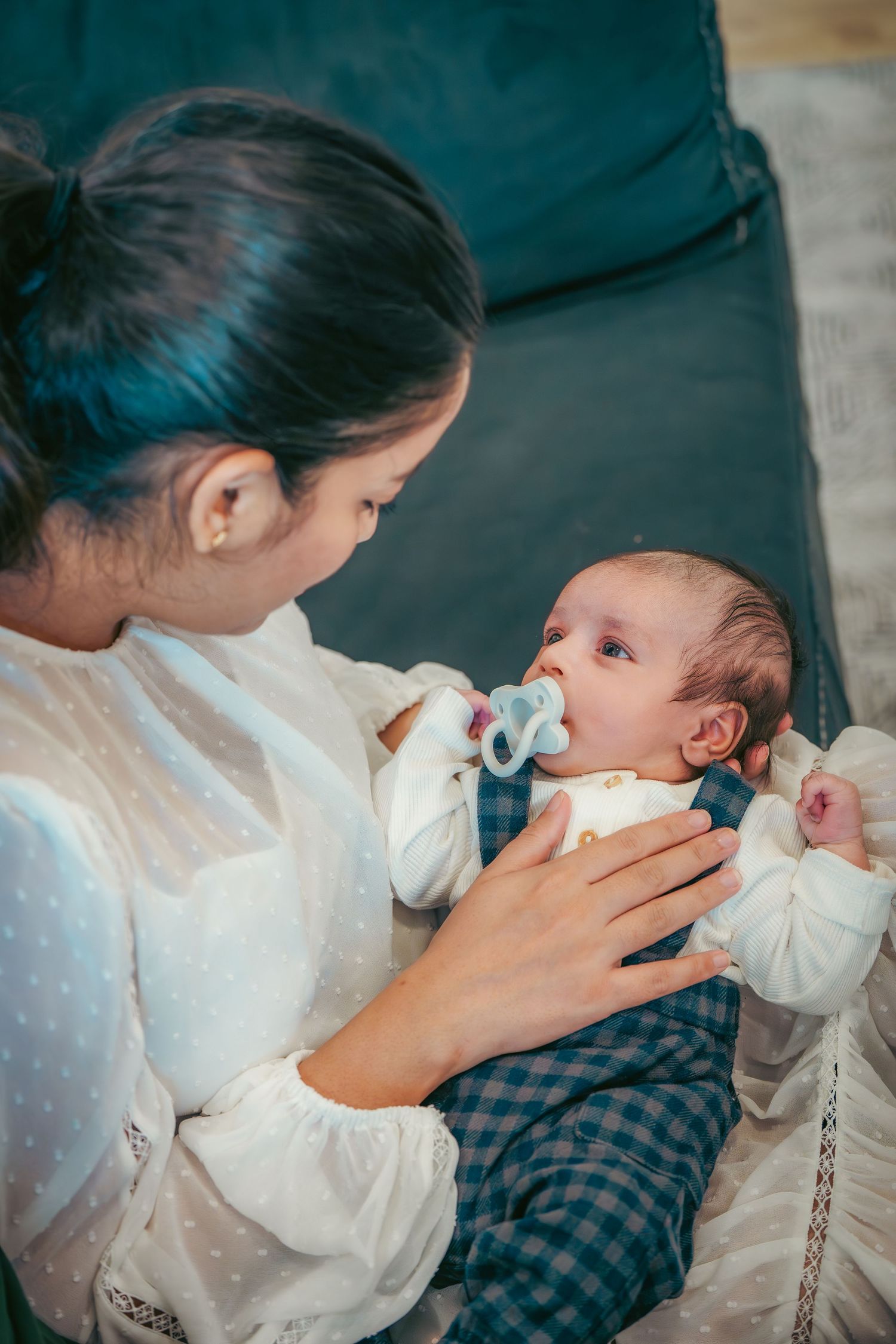 Tender moment between parent and baby during feeding time.